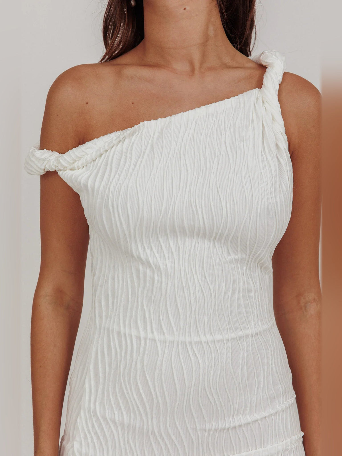 White one-shoulder mini dress with gathered strap and ruched bodice detail