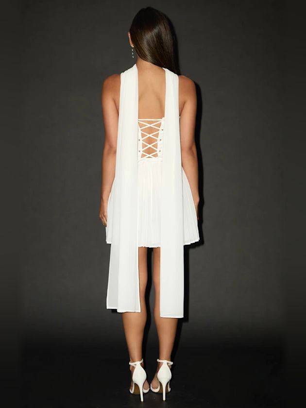 White backless mini dress with crisscross lace-up back and draped overlay