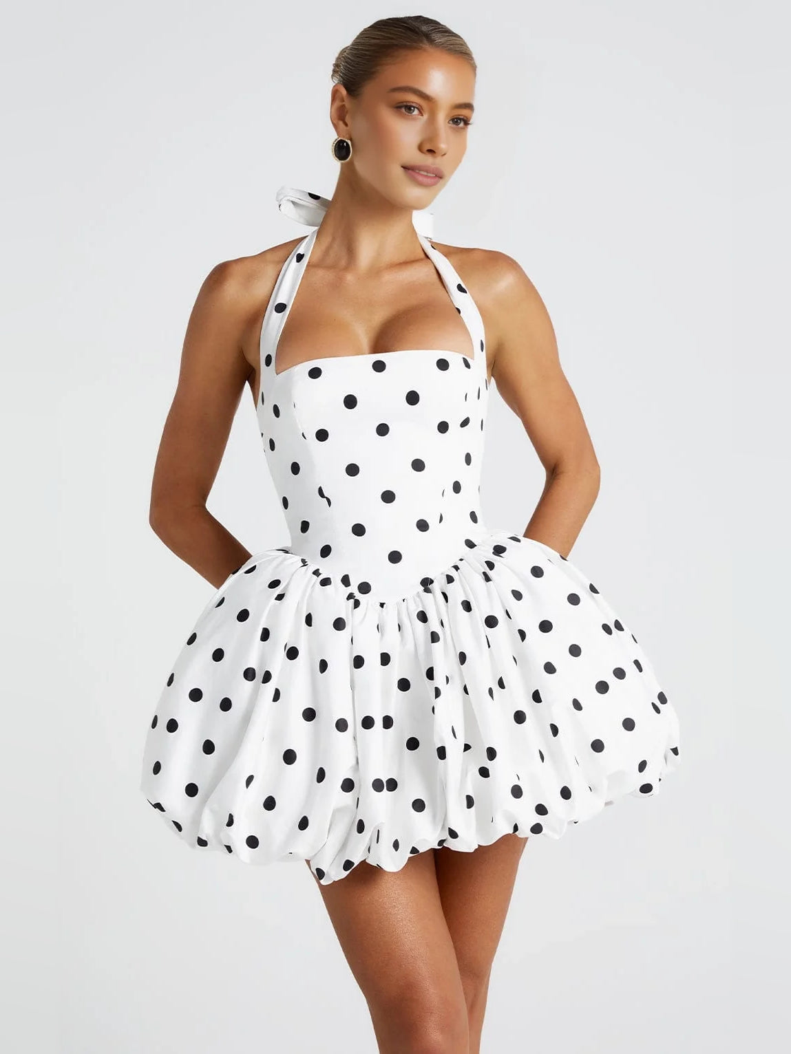 Front view of polka-dot corset bow halter mini dress with puffed fit-and-flare skirt, black and white
