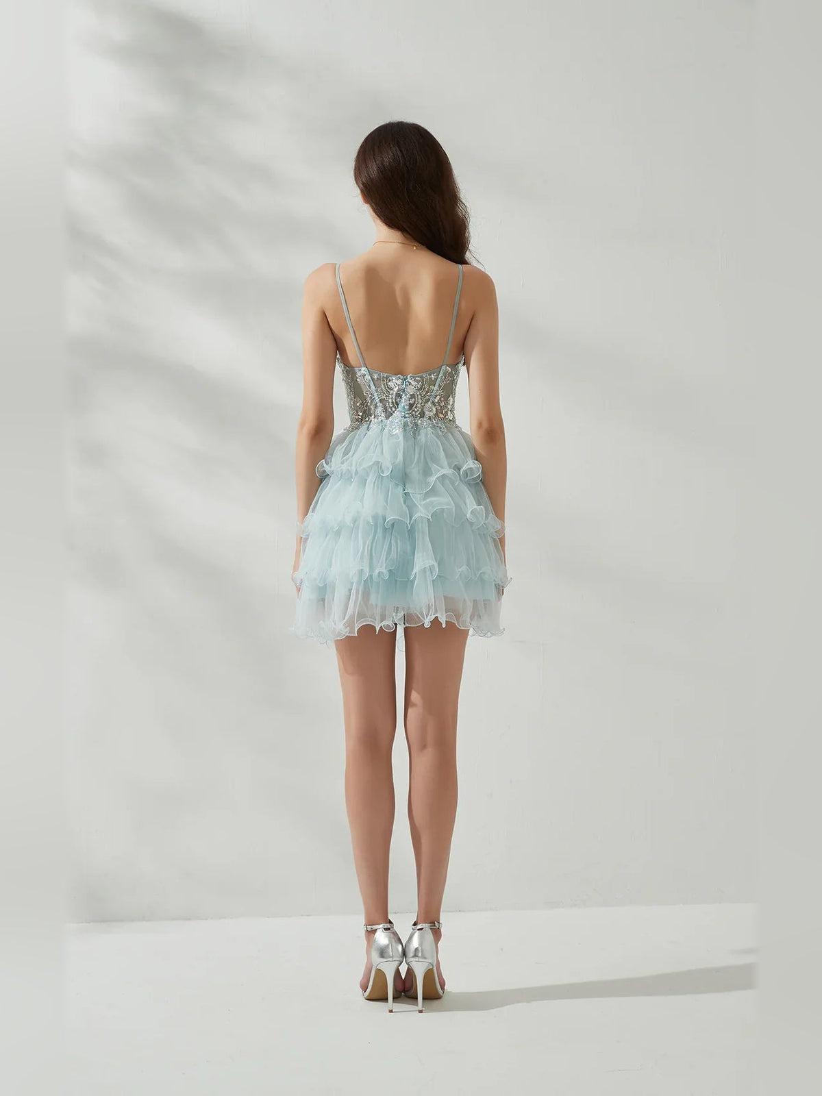 Baby blue A-line mini tulle dress, tiered ruffles from back view with thin straps