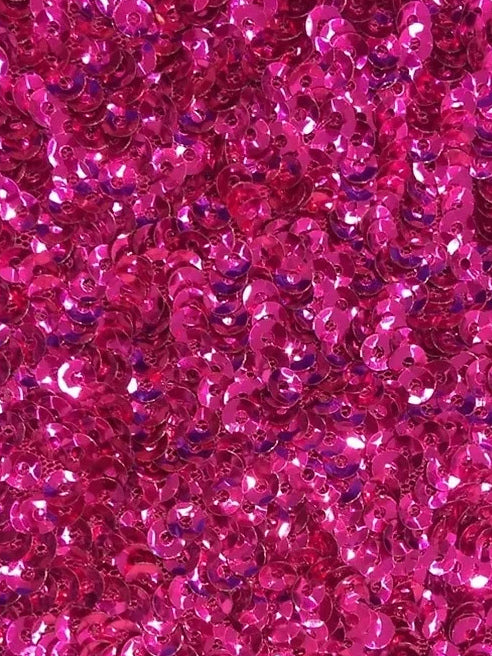 Close-up of hot pink sequin fabric with reflective round sequins