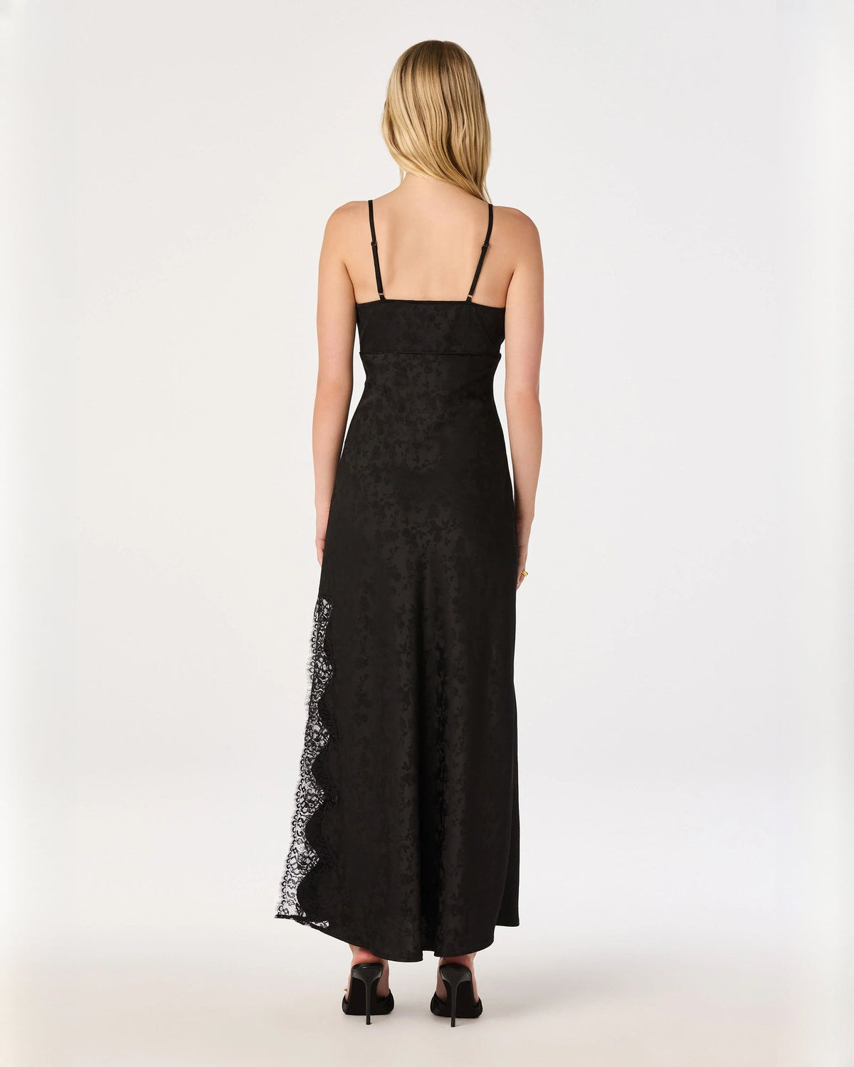 Black sleeveless A-line maxi dress, open back with lace-trim sheer side panel.