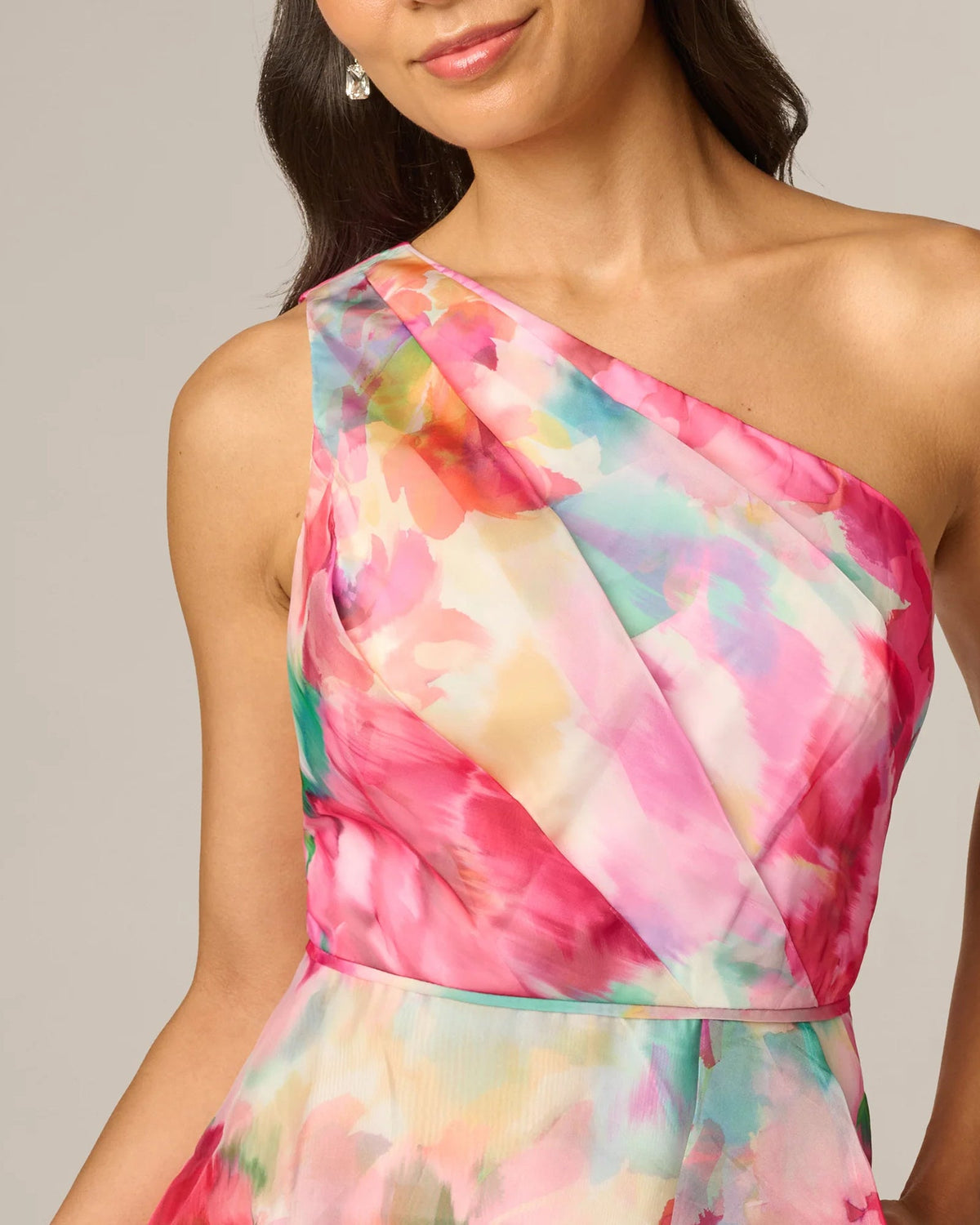 One-shoulder midi dress close-up: diagonal sash neckline and watercolor floral print.