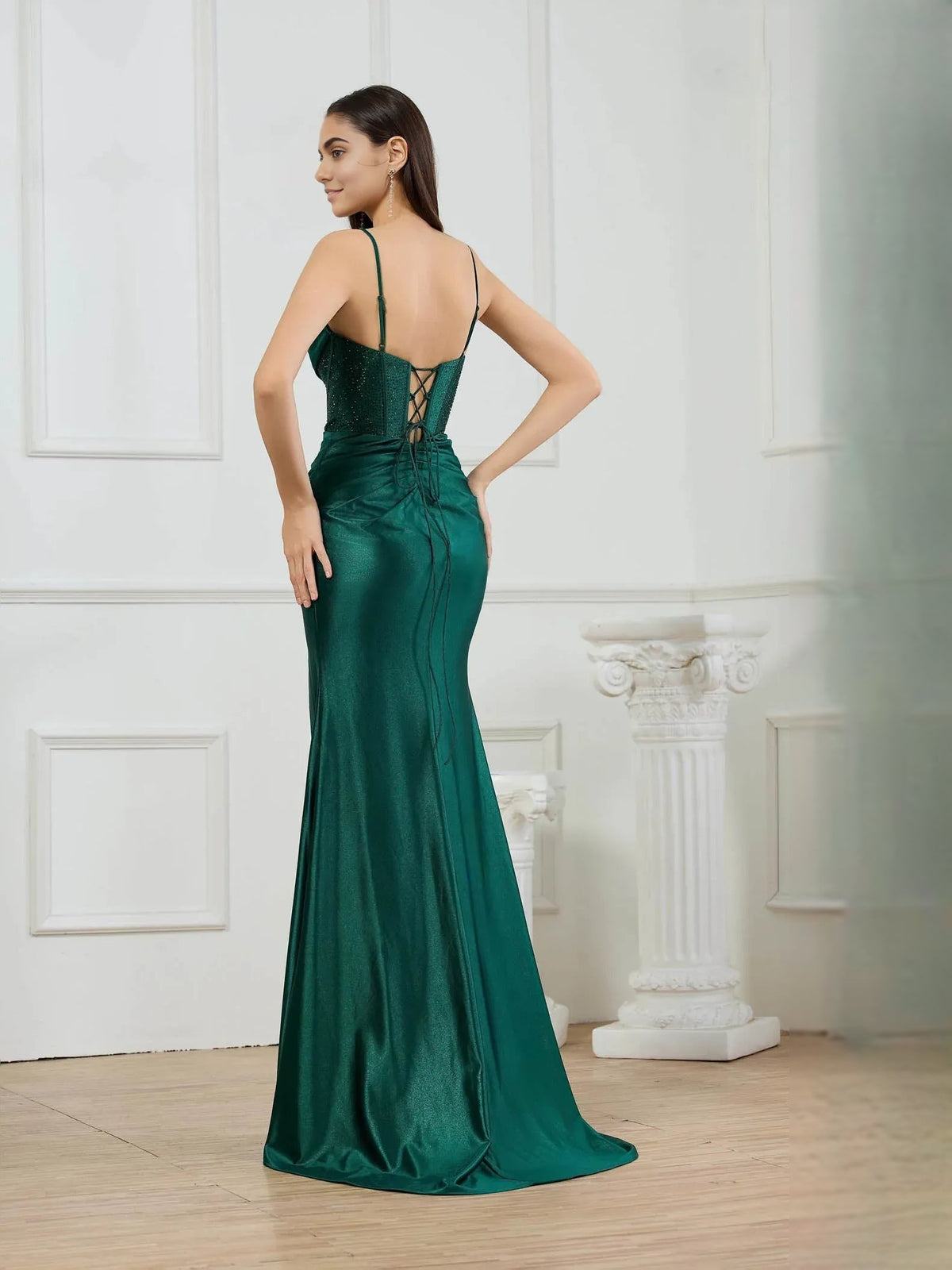 Dark green mermaid formal dress, cowl neckline, corset back, and front slit (back view)