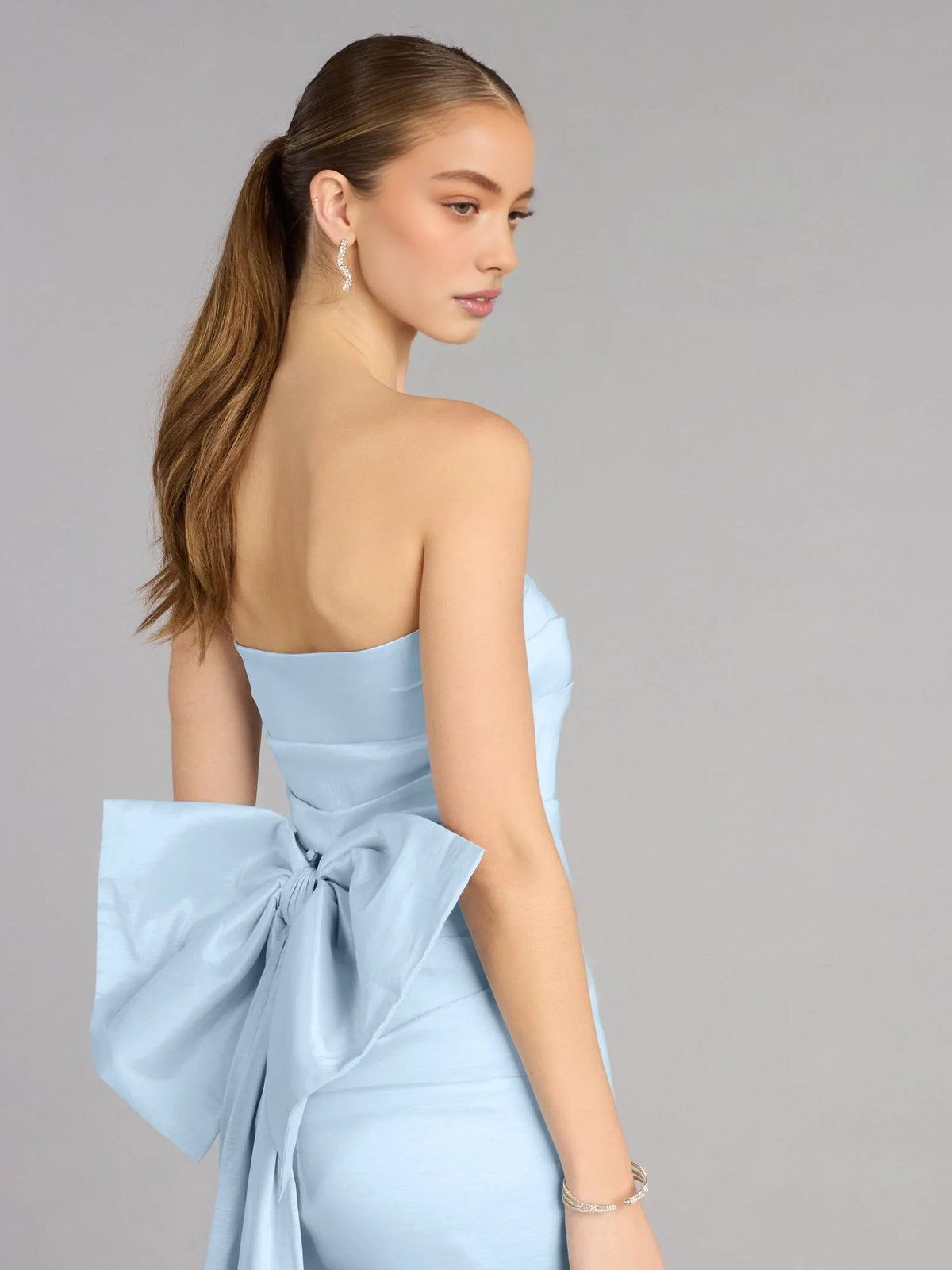 Sky-blue strapless satin mini dress with large draped bow detail on back