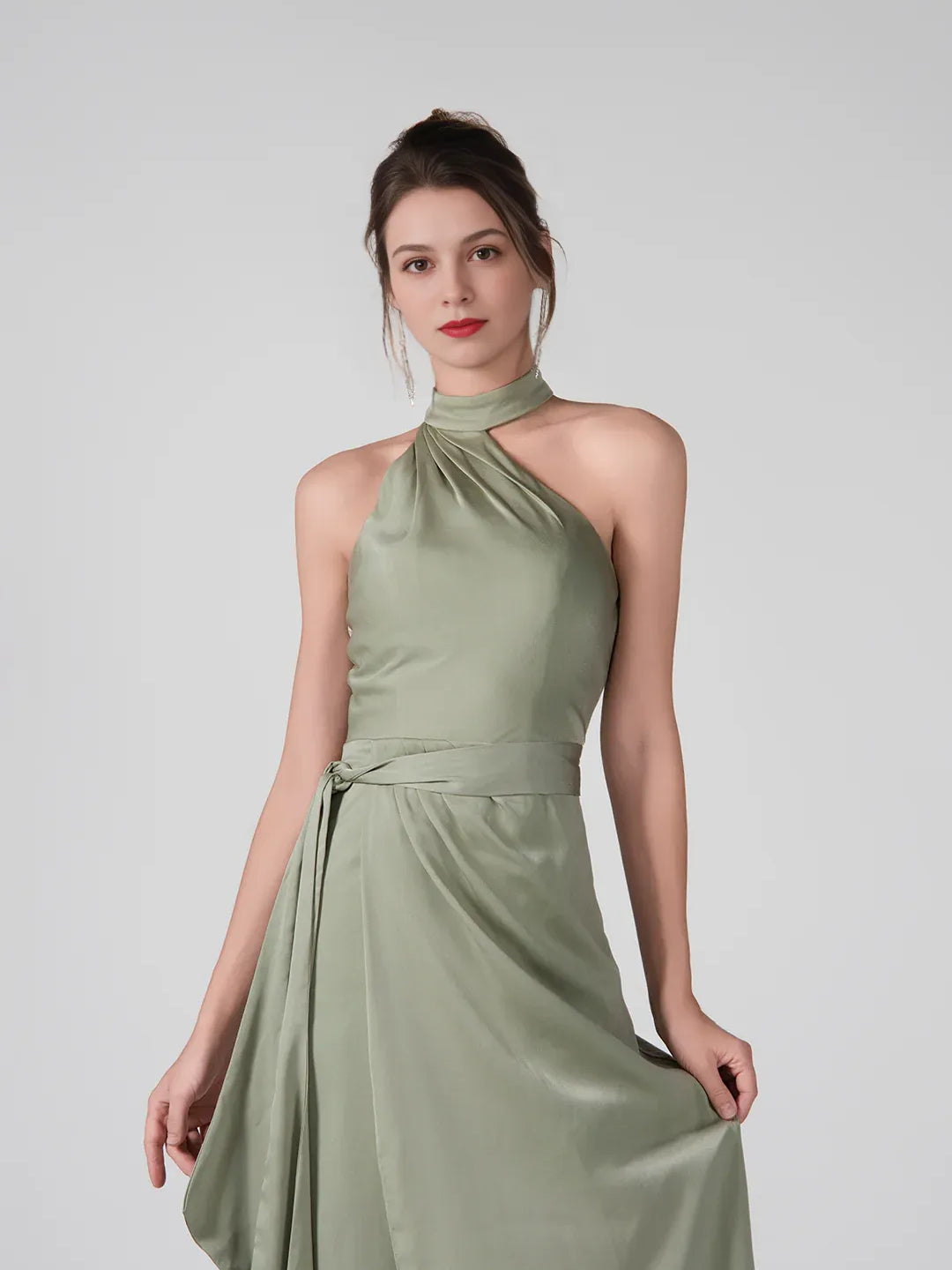 Dusty sage halter neck formal dress with ruched waist and front slit, floor-length.