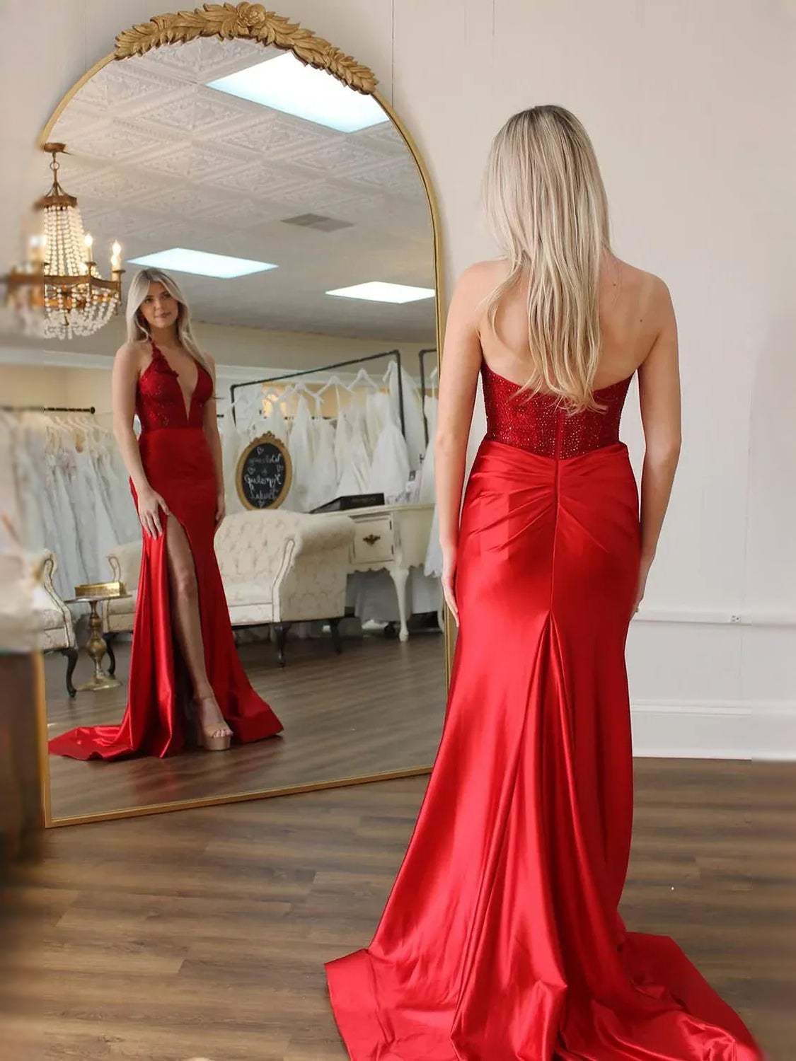 Back view of red satin mermaid prom dress with floral lace bodice and long train
