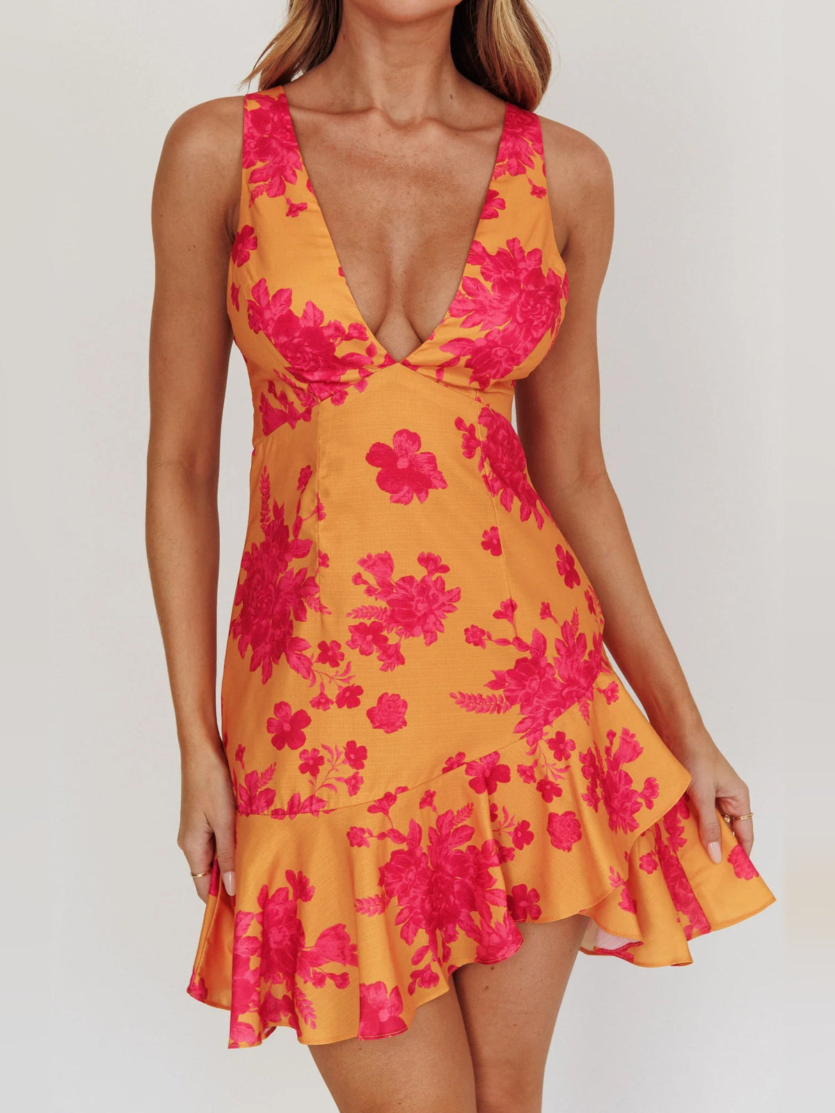 Orange floral mini dress with V-neck, crisscross bodice, and ruffled skirt