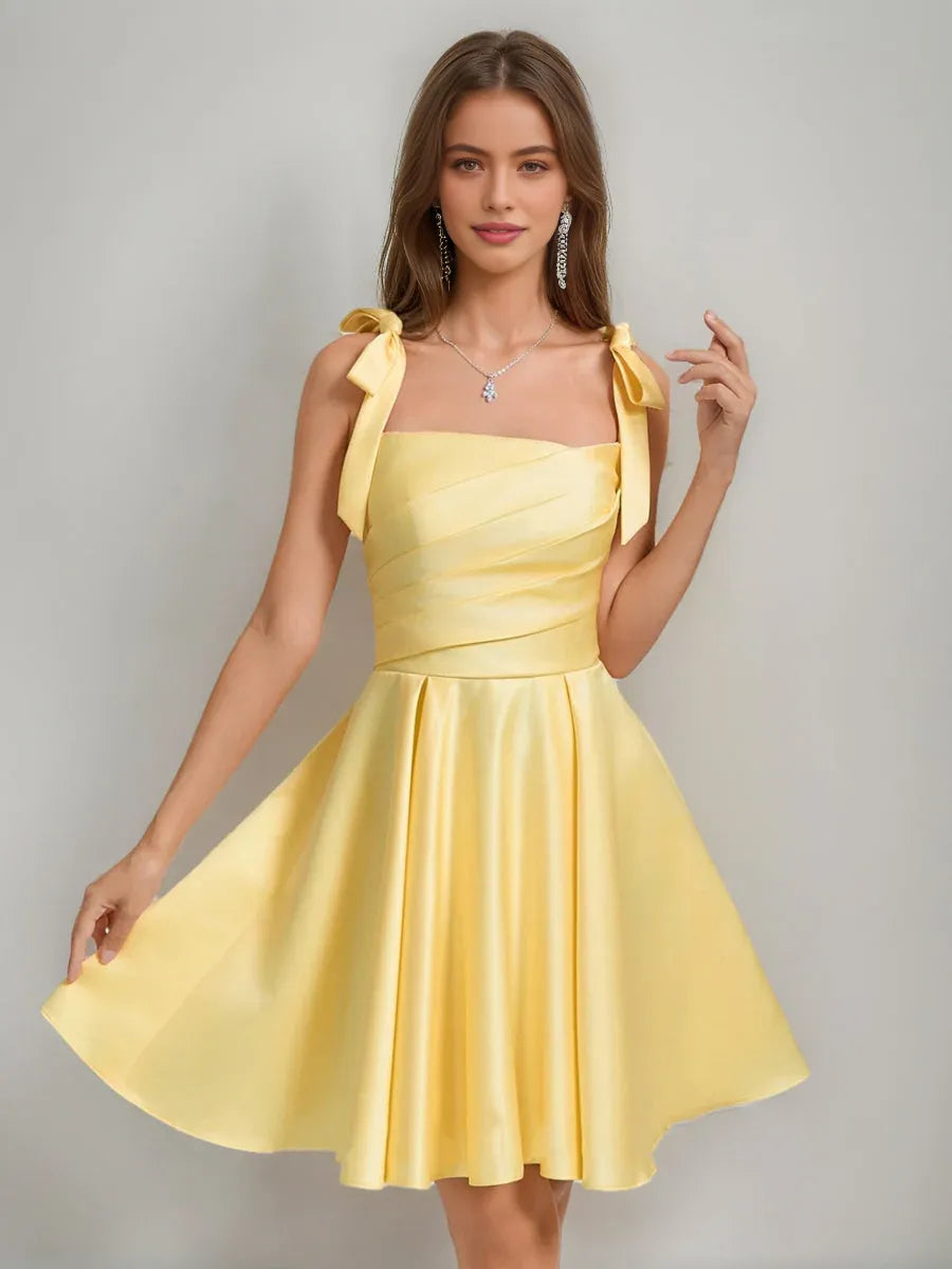 Yellow satin square-neck A-line short dress with bow shoulder ties and flared skirt.
