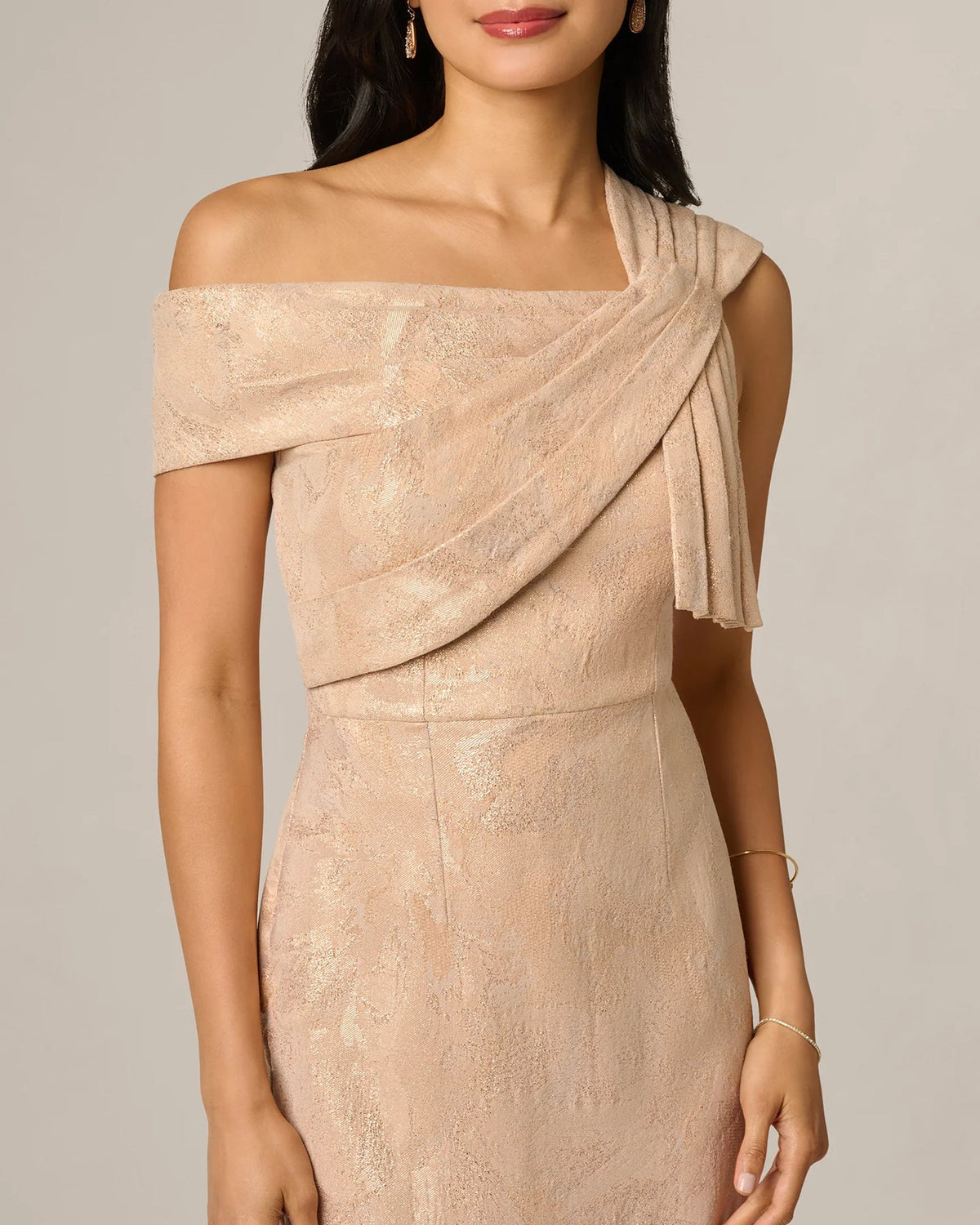Champagne off-shoulder sheath maxi dress with diagonal sash and bow at waist