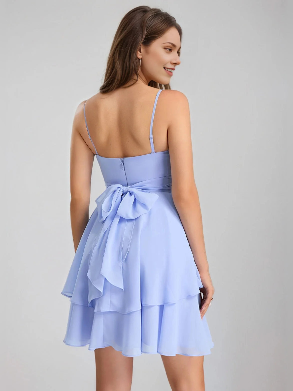 Light blue mini dress with V-neck straps, open back, and tiered ruffle skirt