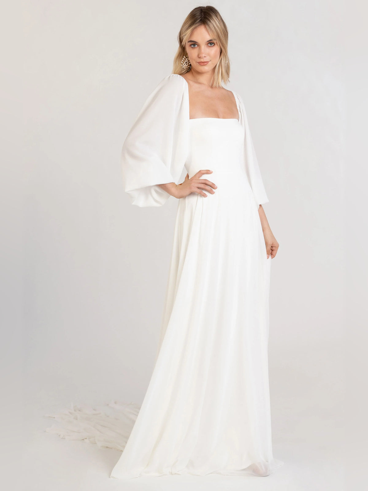 Off-white square-neck A-line dress with long puff sleeves and pleated, flowing hem