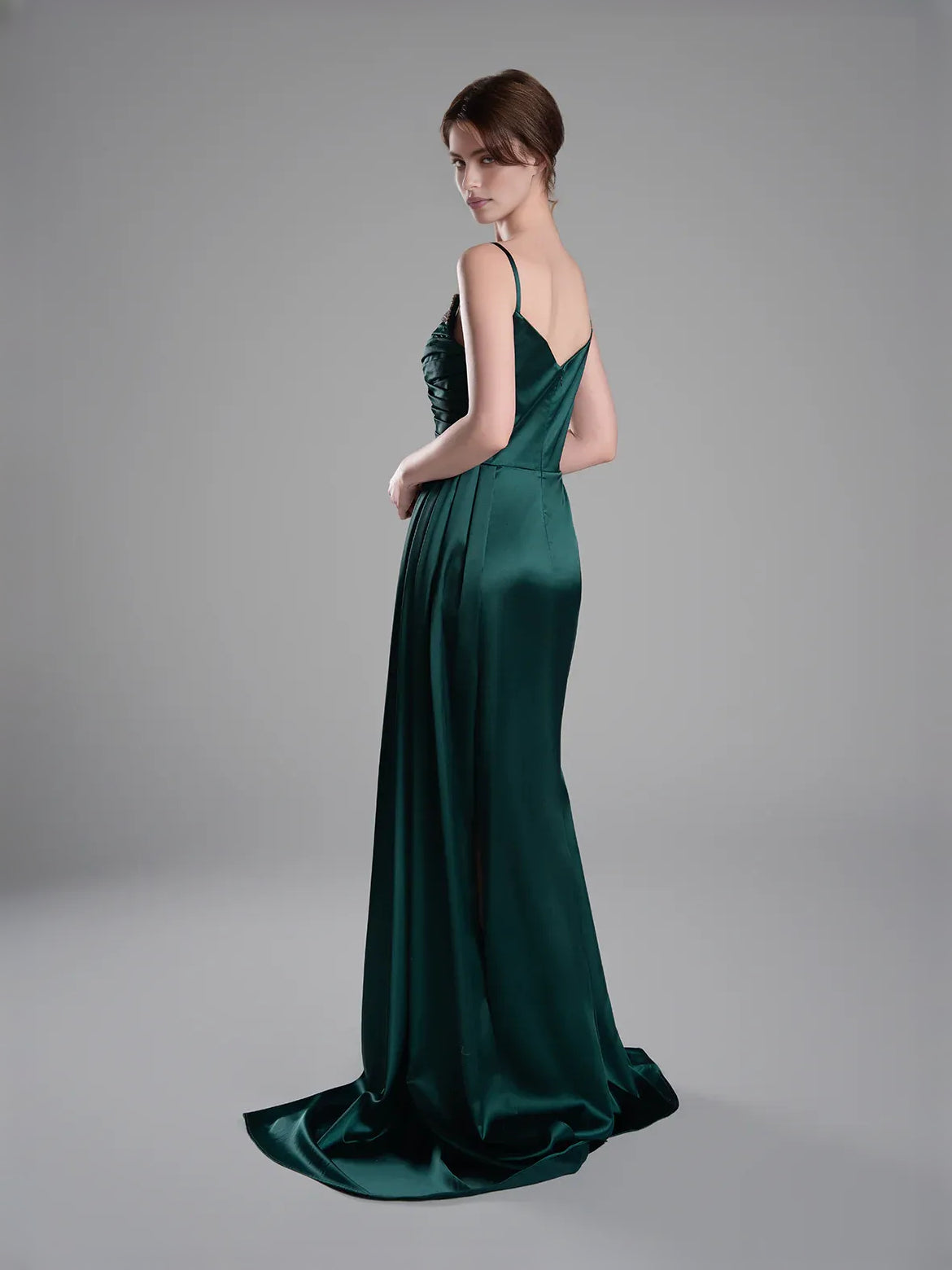 Peacock green satin evening dress with spaghetti straps, draped back, and high slit.