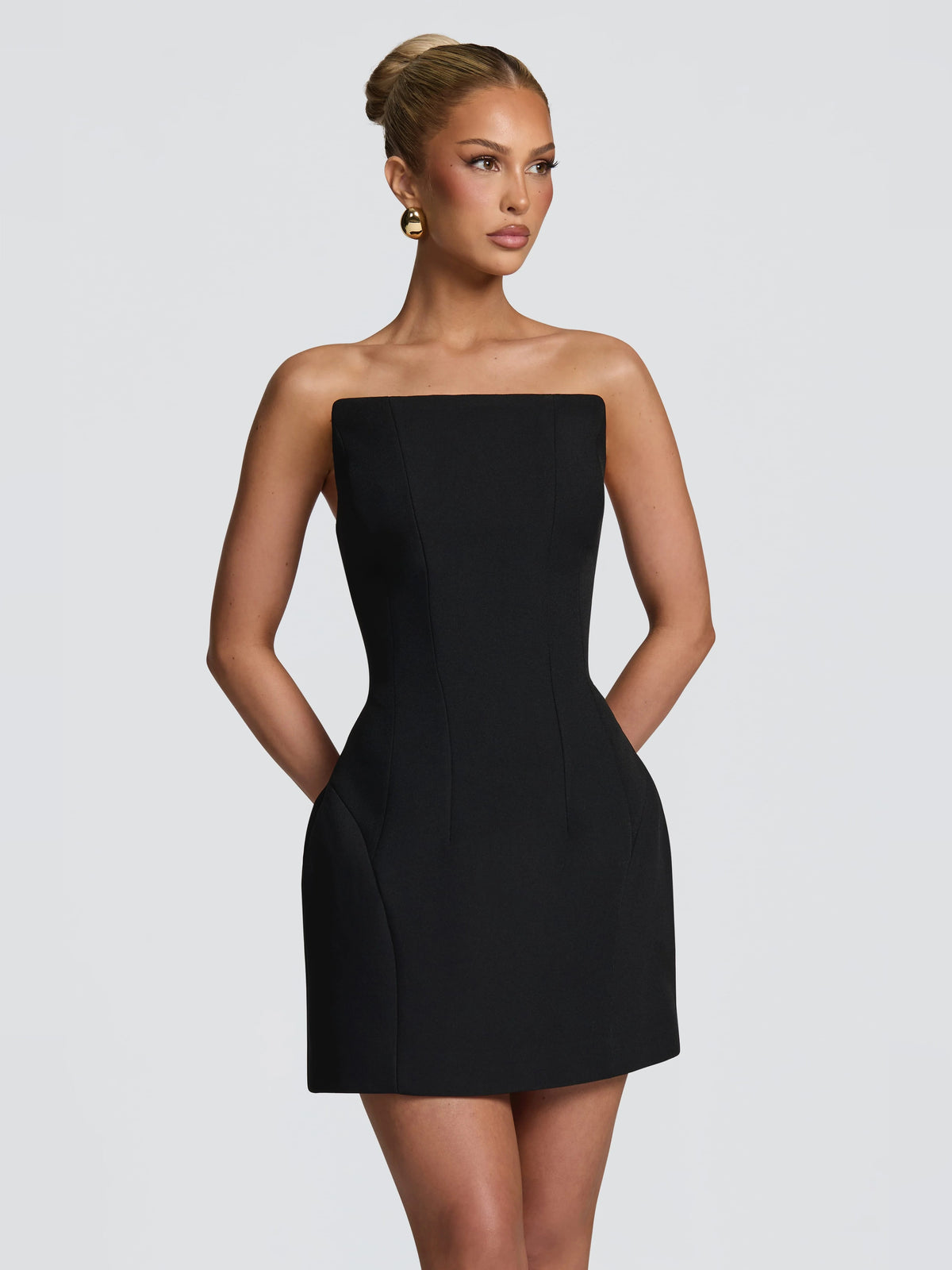 Black strapless mini dress with tailored seams and fitted waist
