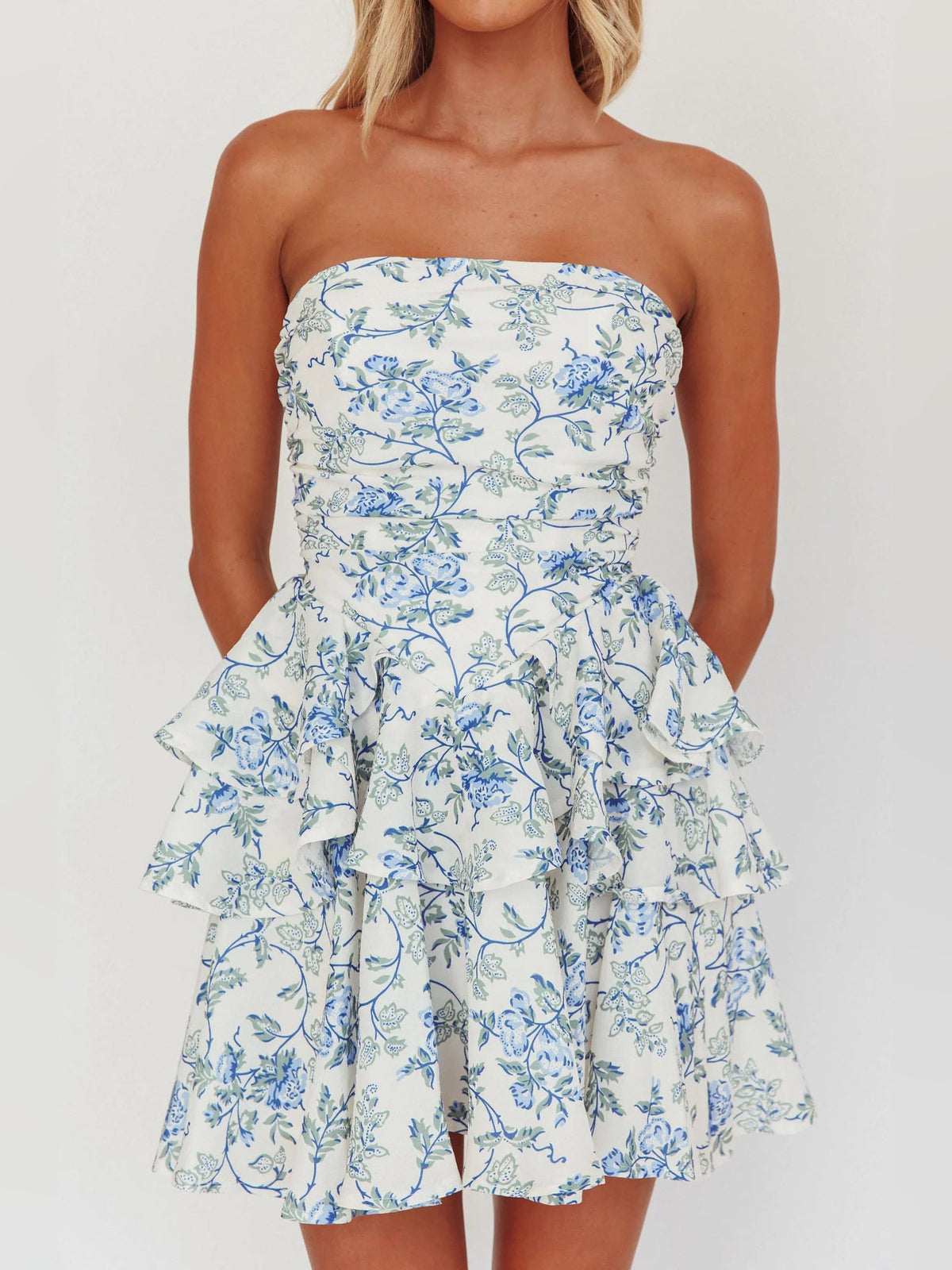 Blue floral strapless mini dress with sweetheart neckline and tiered ruffle layers.