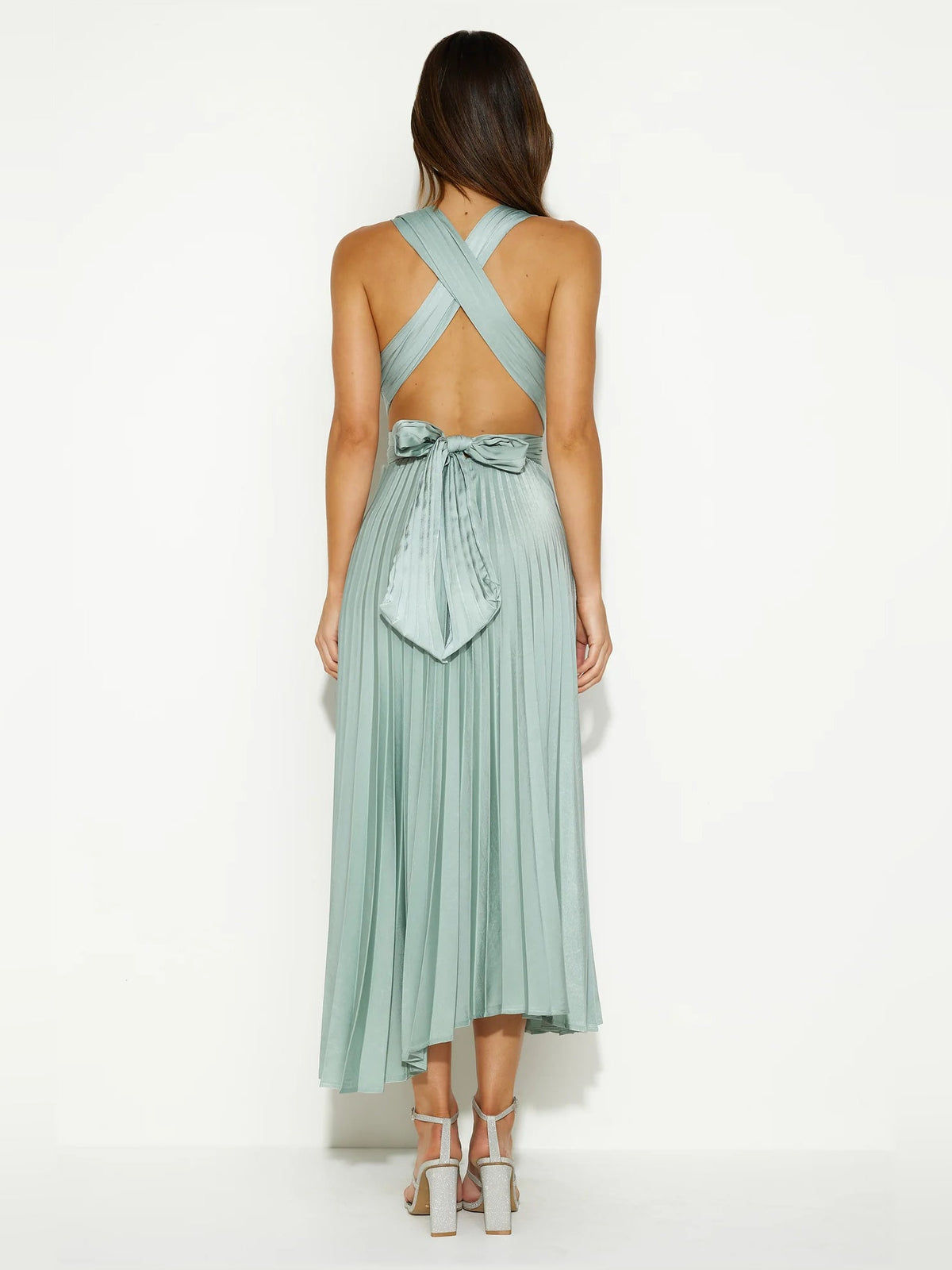 Back view of light sage midi formal dress with crisscross straps and tied waist bow