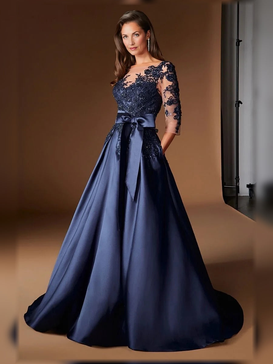 Dark blue pleated satin A-line gown with lace illusion neckline and waist bow