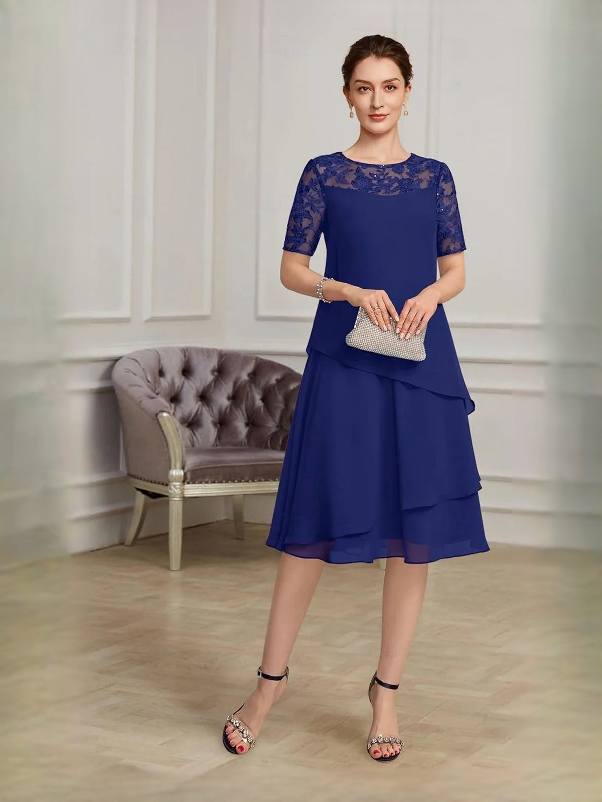 Navy blue lace-yoke chiffon midi dress with short sleeves and layered tiered A-line skirt.