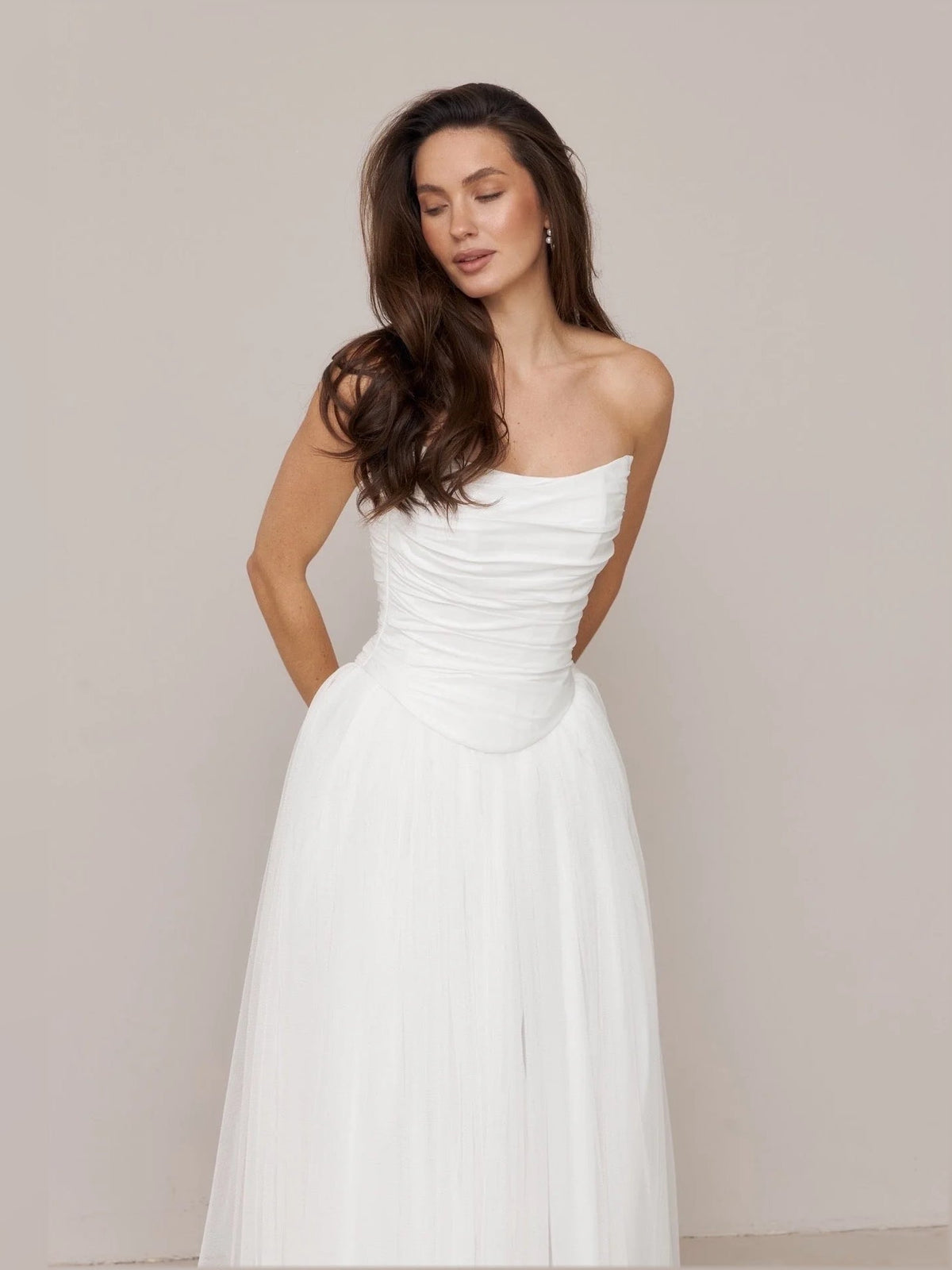 Ivory strapless wedding dress with ruched bodice and full A-line skirt, front close view