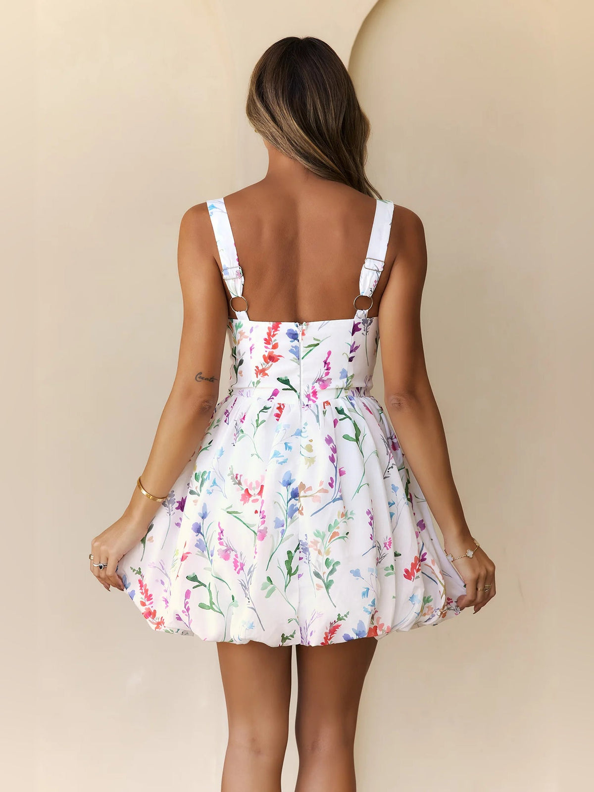 Back view of white floral mini dress with adjustable spaghetti straps