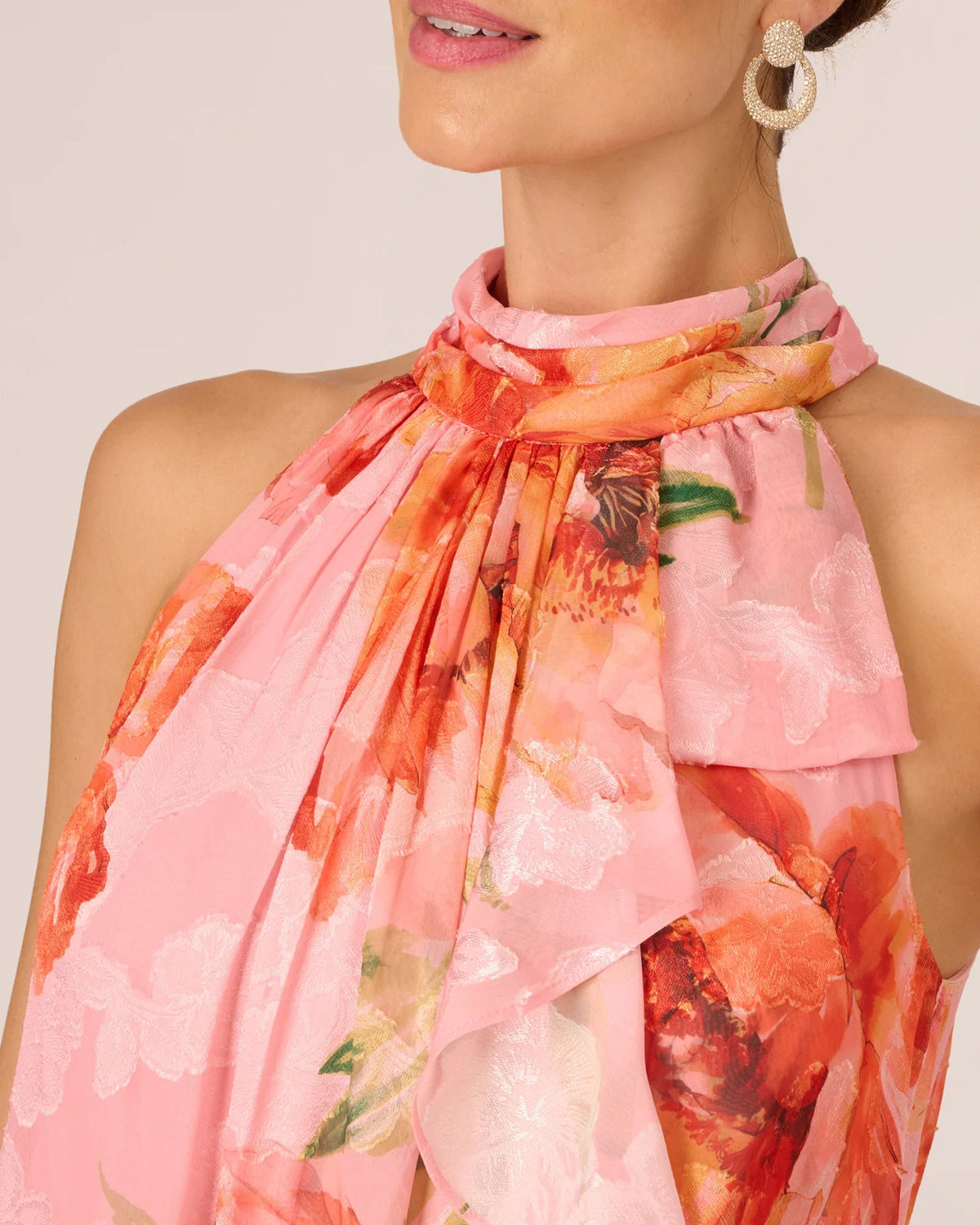 Pink floral halter neckline with tied drape and ruffled collar detail