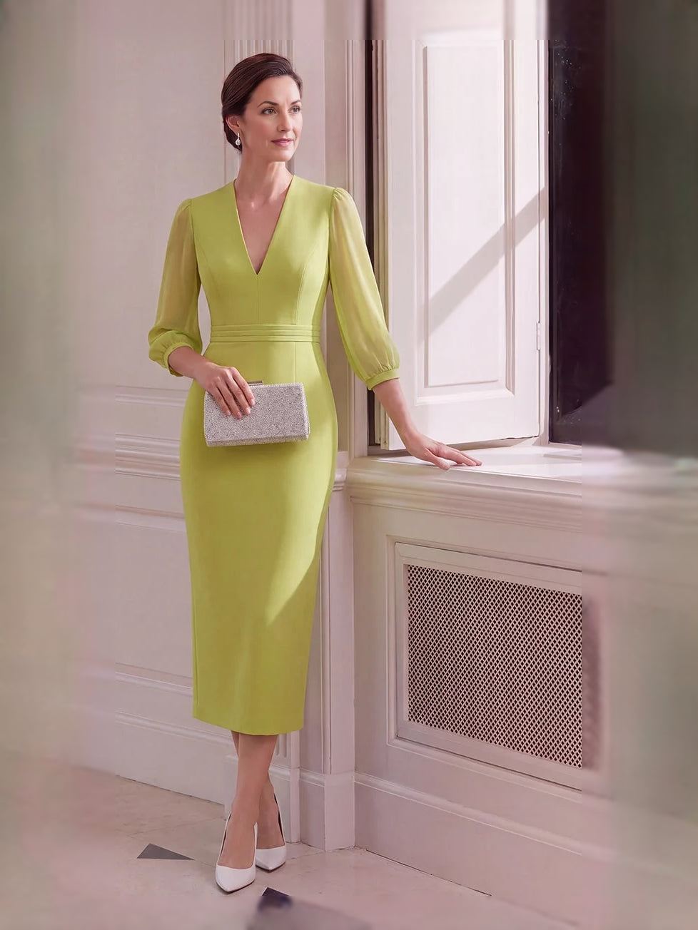 Chartreuse V-neck sheath midi dress, draped back and side slit, angled view.