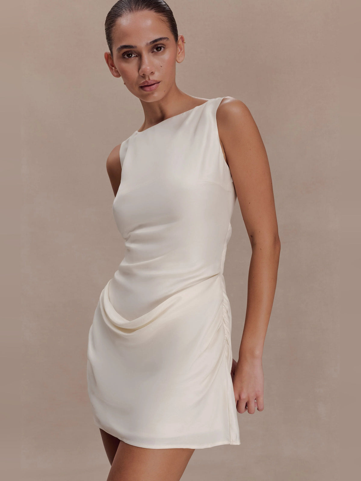 Ivory sleeveless mini dress with draped cowl front and fitted skirt