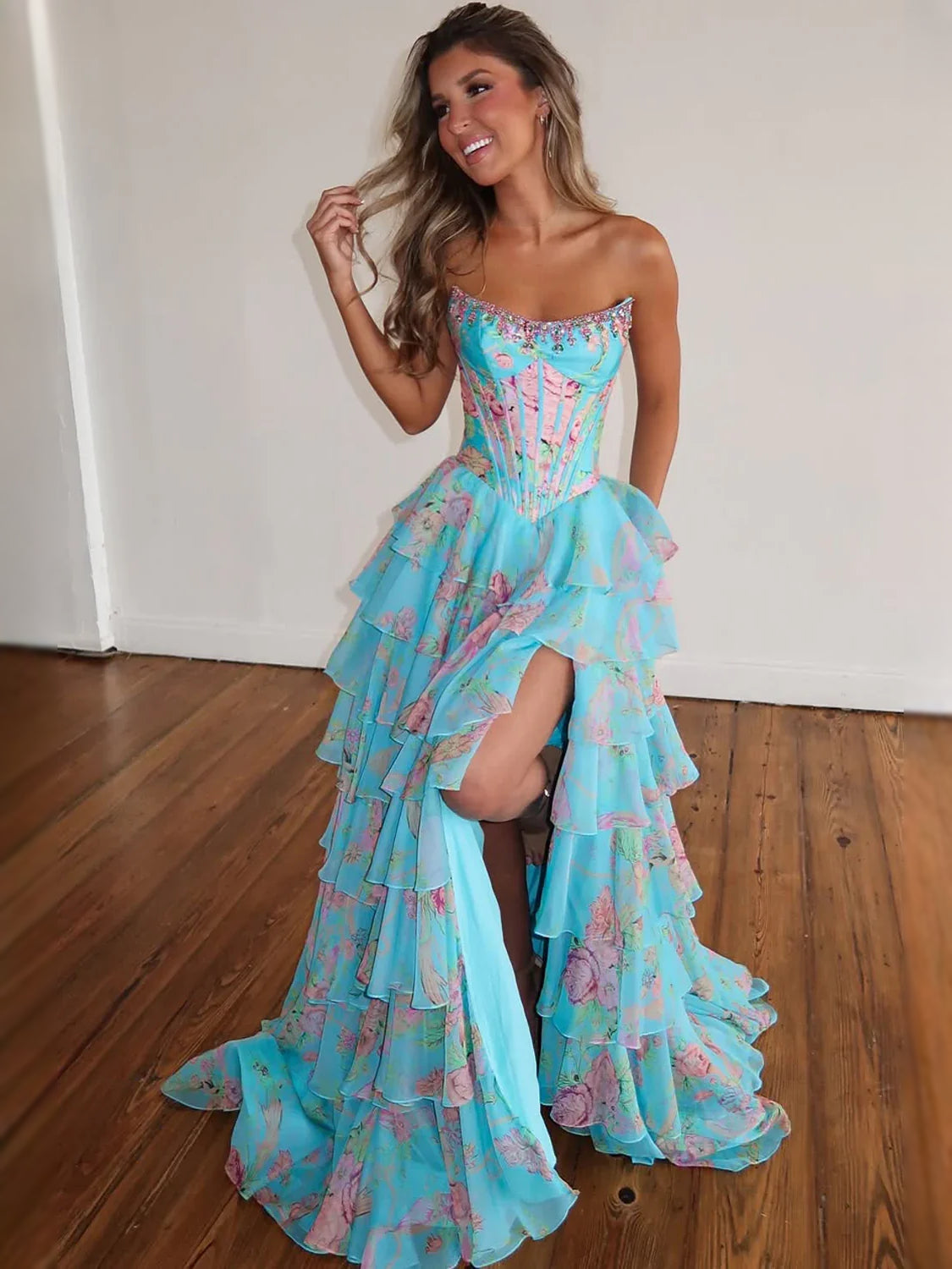 Aqua strapless floral tiered gown with visible side slit and corset bodice