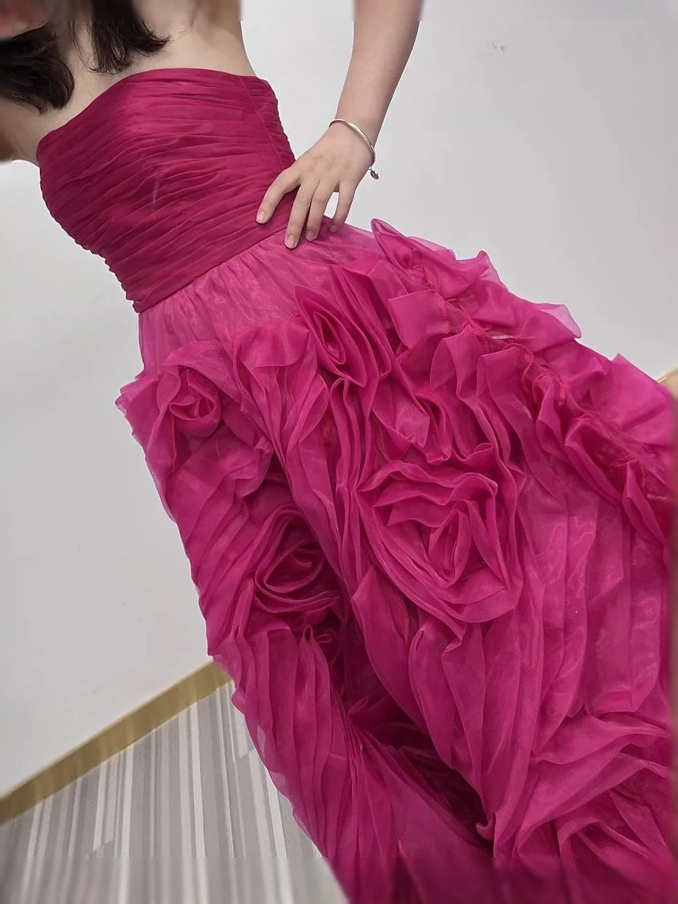 Hot pink strapless ruched corset with layered floral ruffle skirt detail