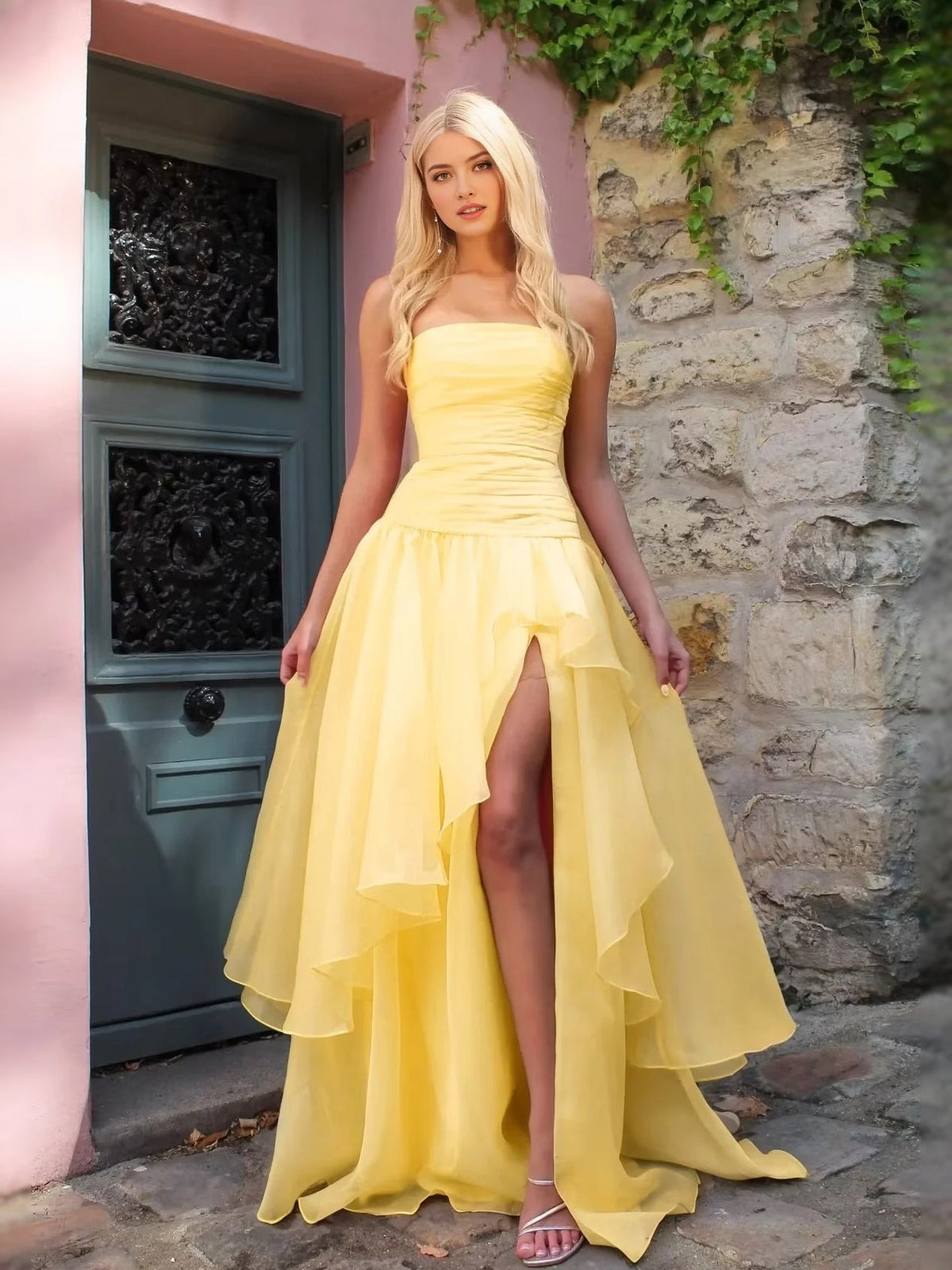 Light yellow strapless ruched prom dress with layered A-line skirt and front slit