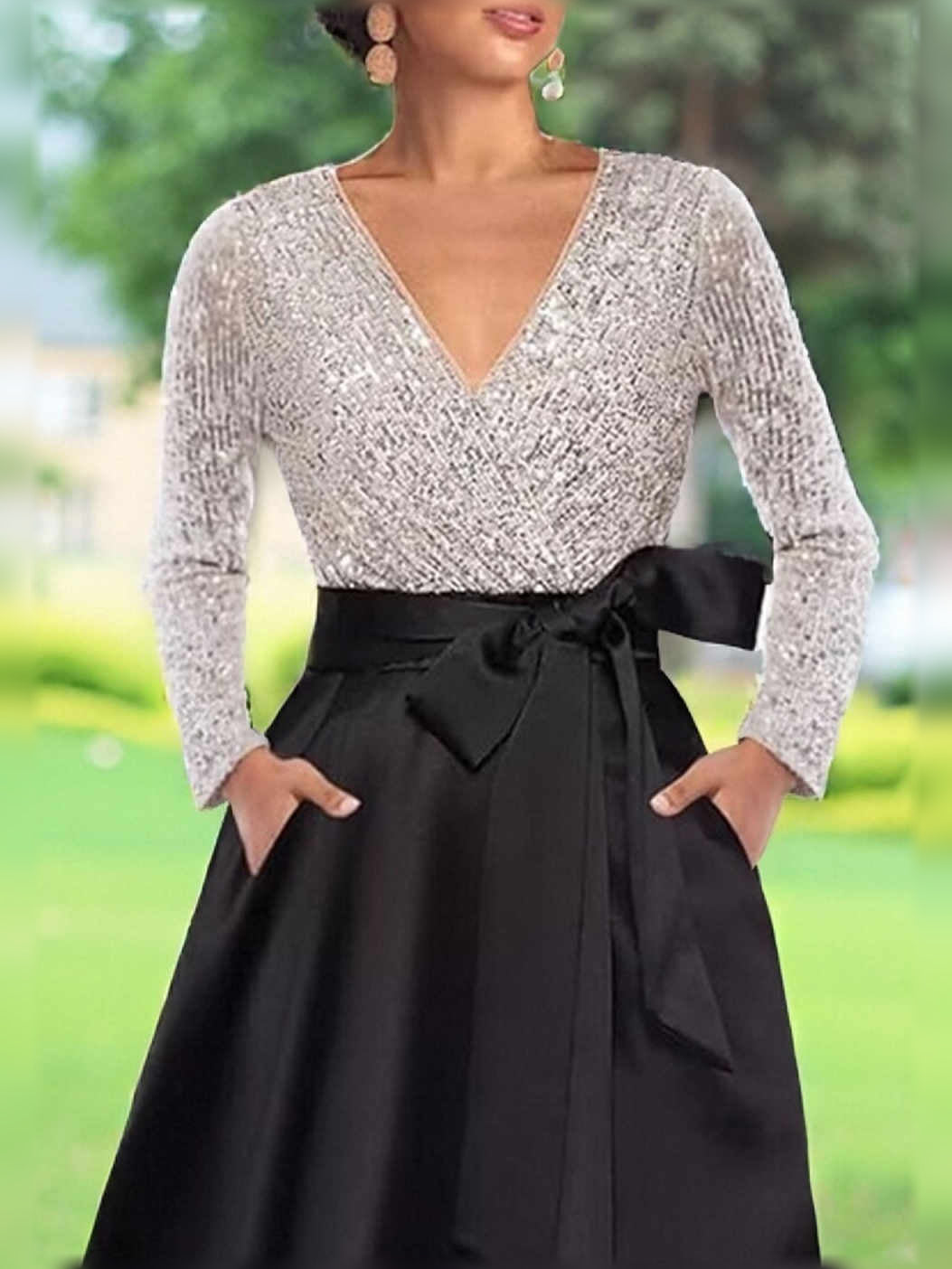 Black A-line formal dress with long-sleeve V-neck sequin bodice, satin skirt, waist bow.