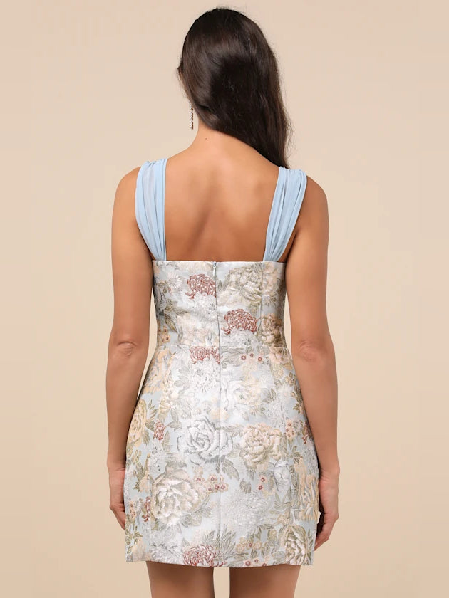 Back view: floral mini dress with light blue straps and center back seam