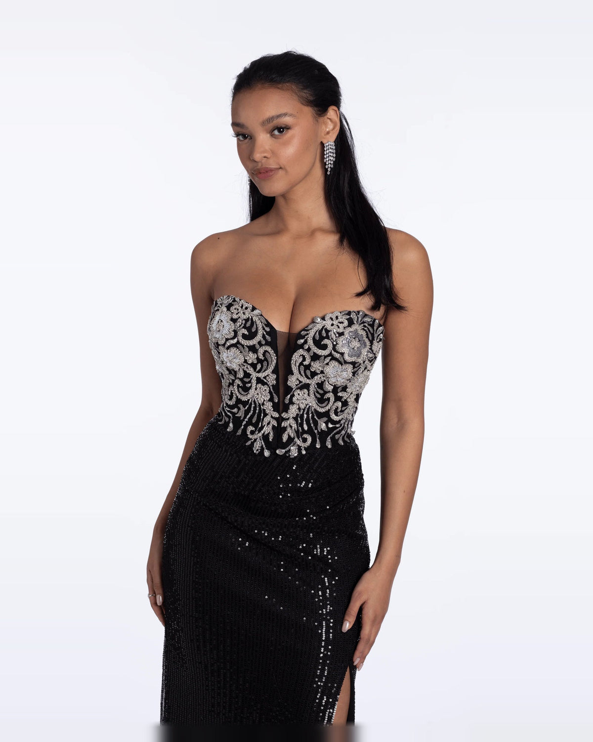 Strapless black maxi prom dress with ornate silver bust corset and ruched skirt.