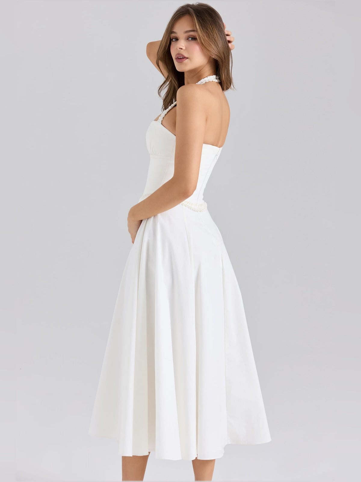 White halter-neck midi dress with ruched back and pleated skirt, side view