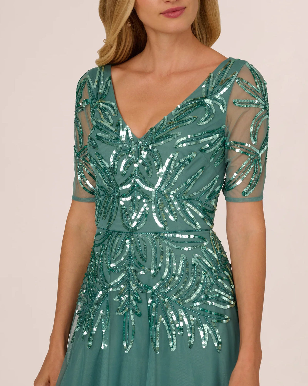 Teal sequin V-neck bodice with short mesh sleeves and glittering leaf-like pattern