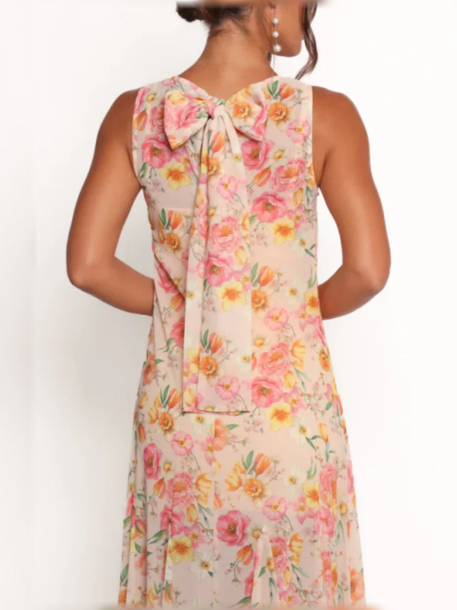 Floral A-line chiffon formal dress, back view with bow detail at neckline, blush print