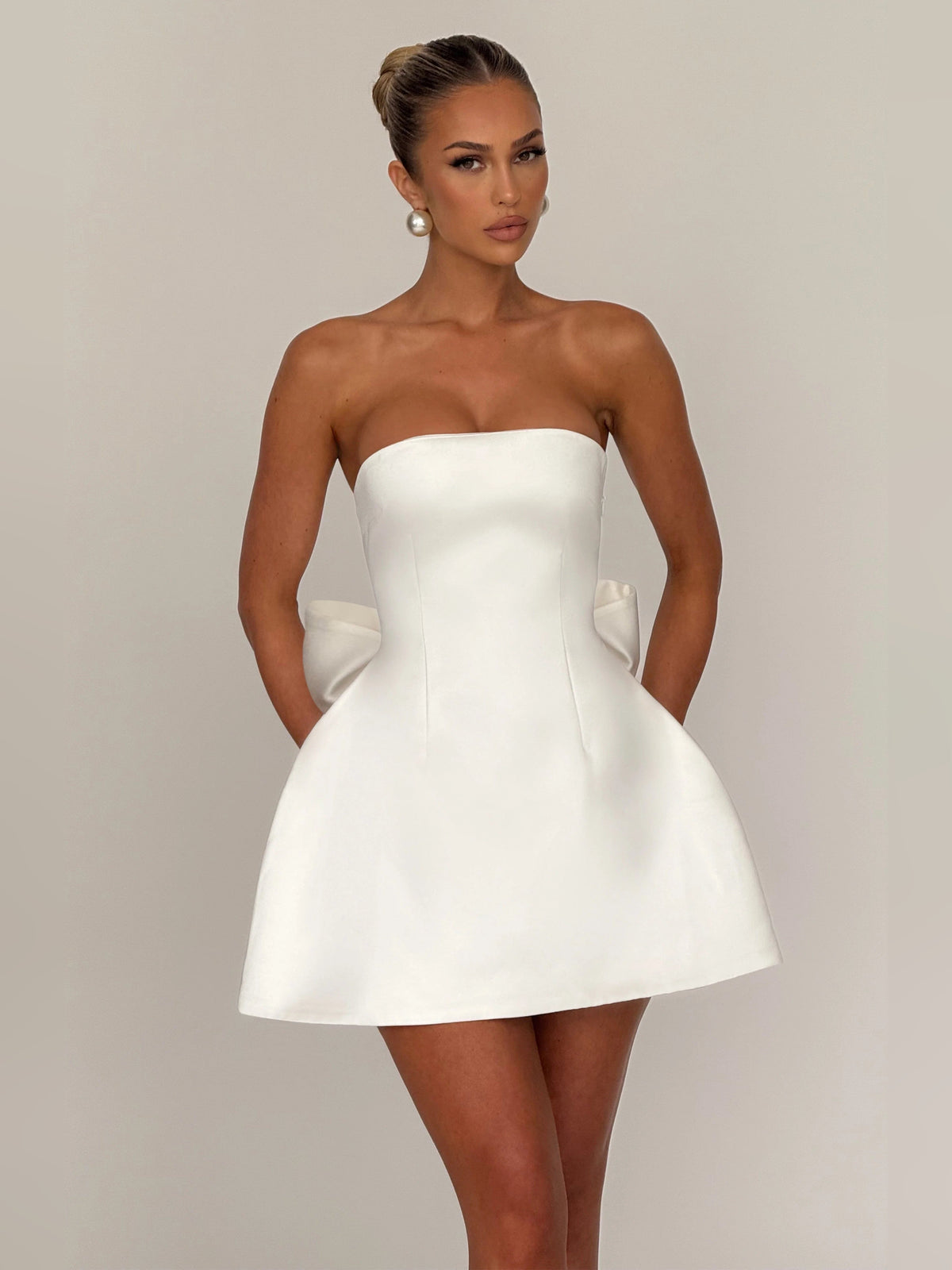 Ivory mini strapless dress with sweetheart neckline and flared A-line skirt, front view.