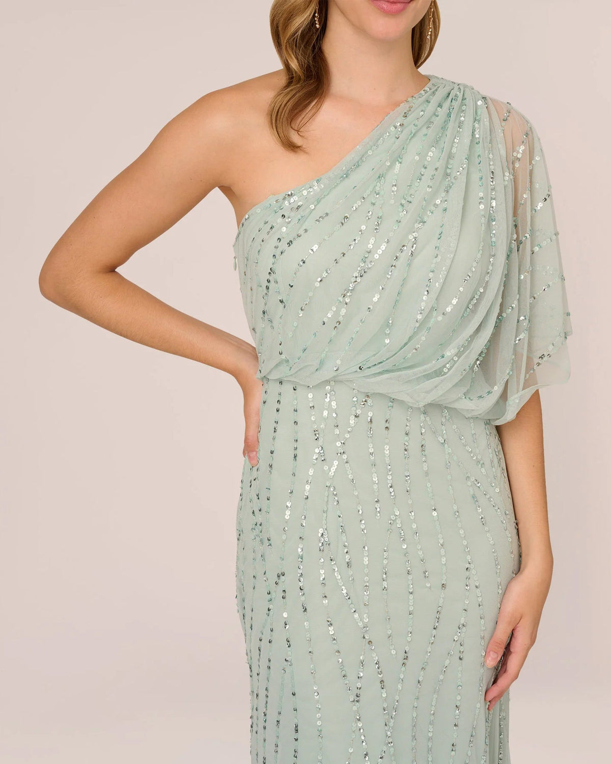 Mint green one-shoulder draped bodice with layered tulle sleeve and silver sequins