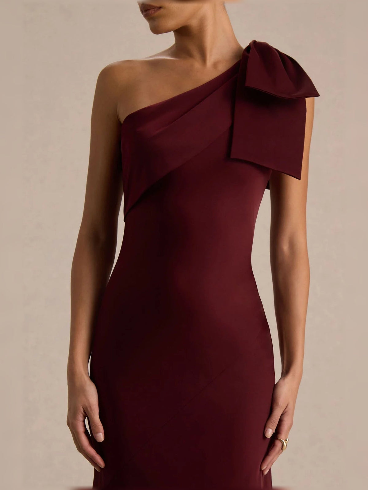 Burgundy one-shoulder satin fitted bodice with draped bow neckline detail