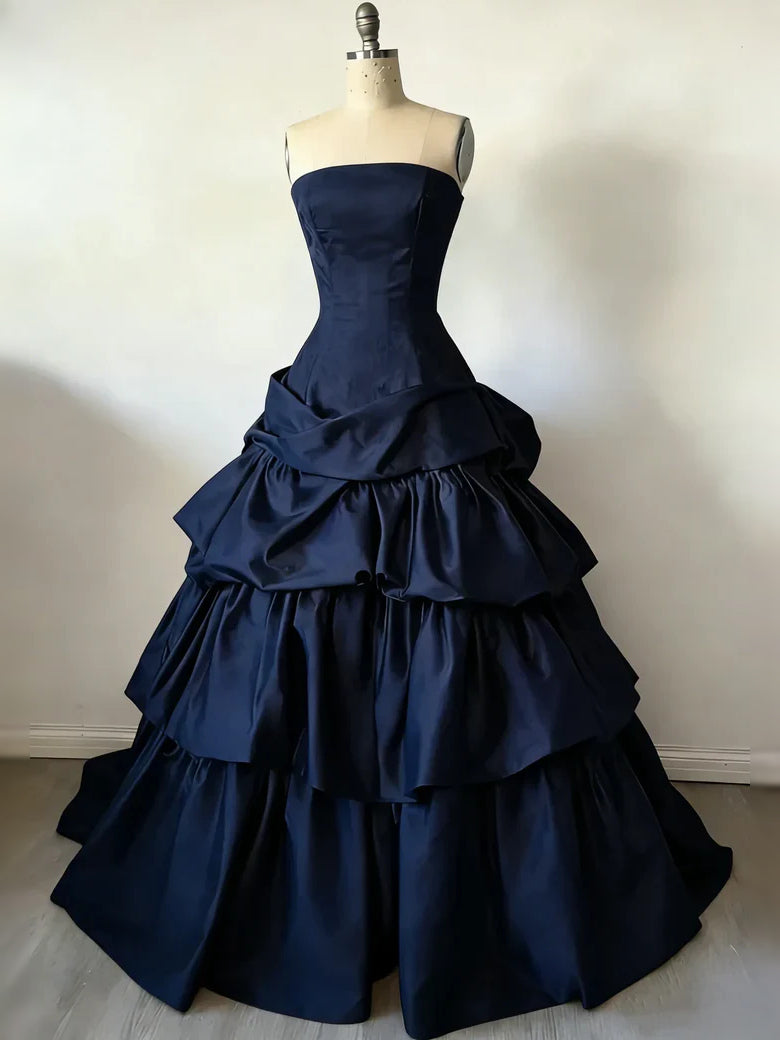 Navy satin strapless corset ball gown with tiered ruffle skirt on mannequin