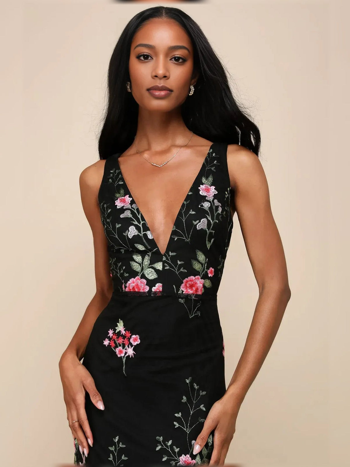Black floral V-neck sheath dress detail at neckline and fitted waist