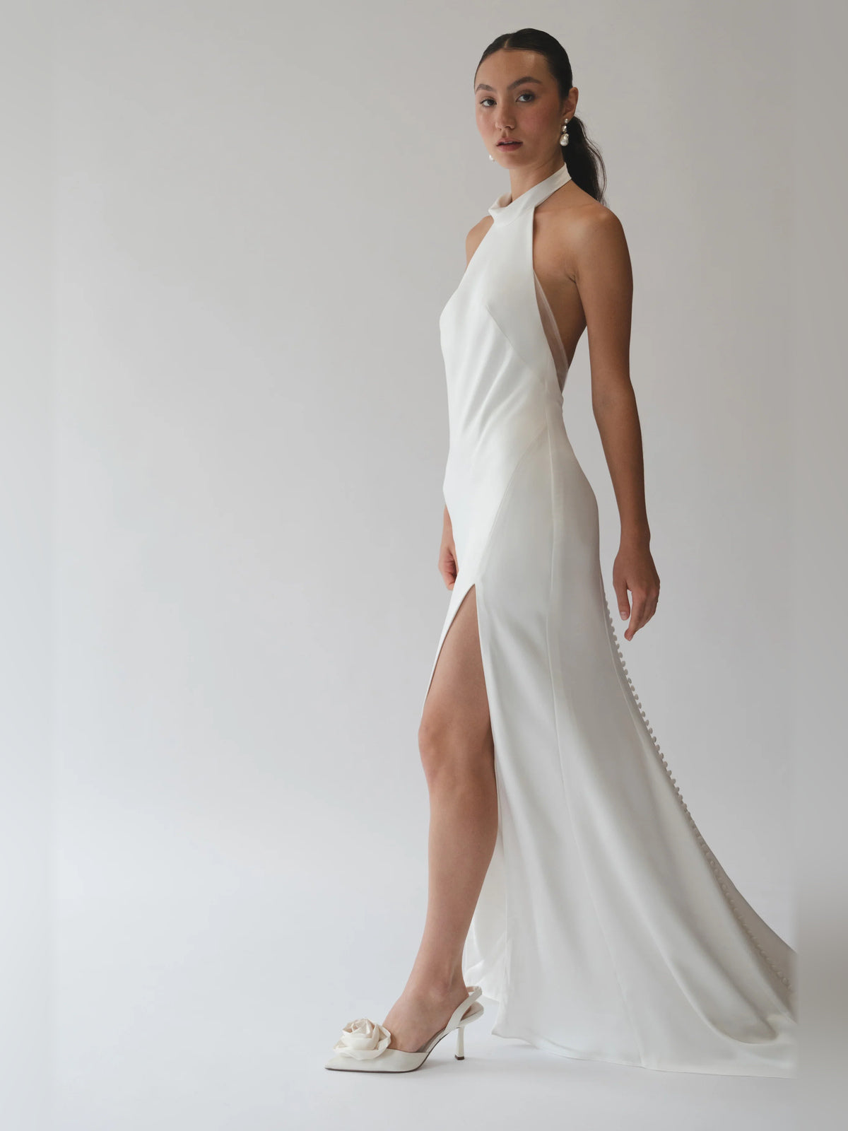 Ivory halter sheath formal dress with draped bodice and side slit, floor length