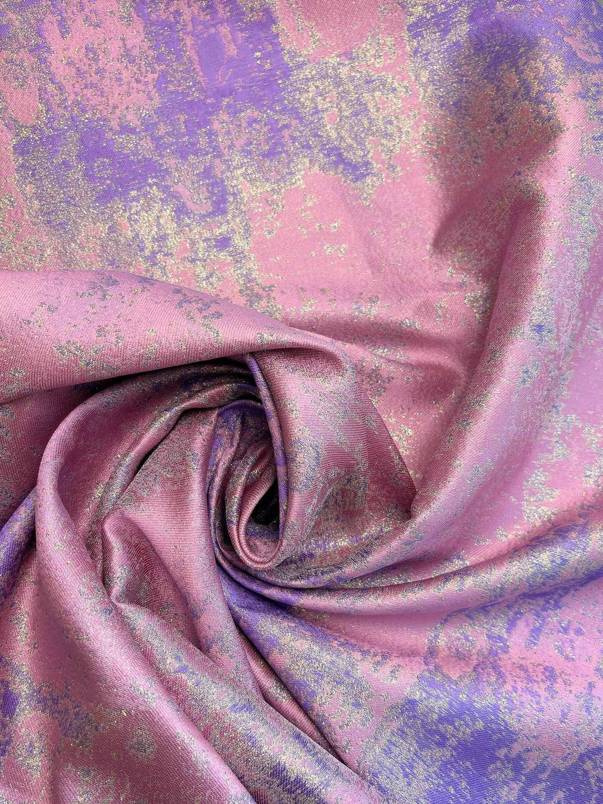 Close-up of pink-purple metallic floral fabric with ruched drape folds