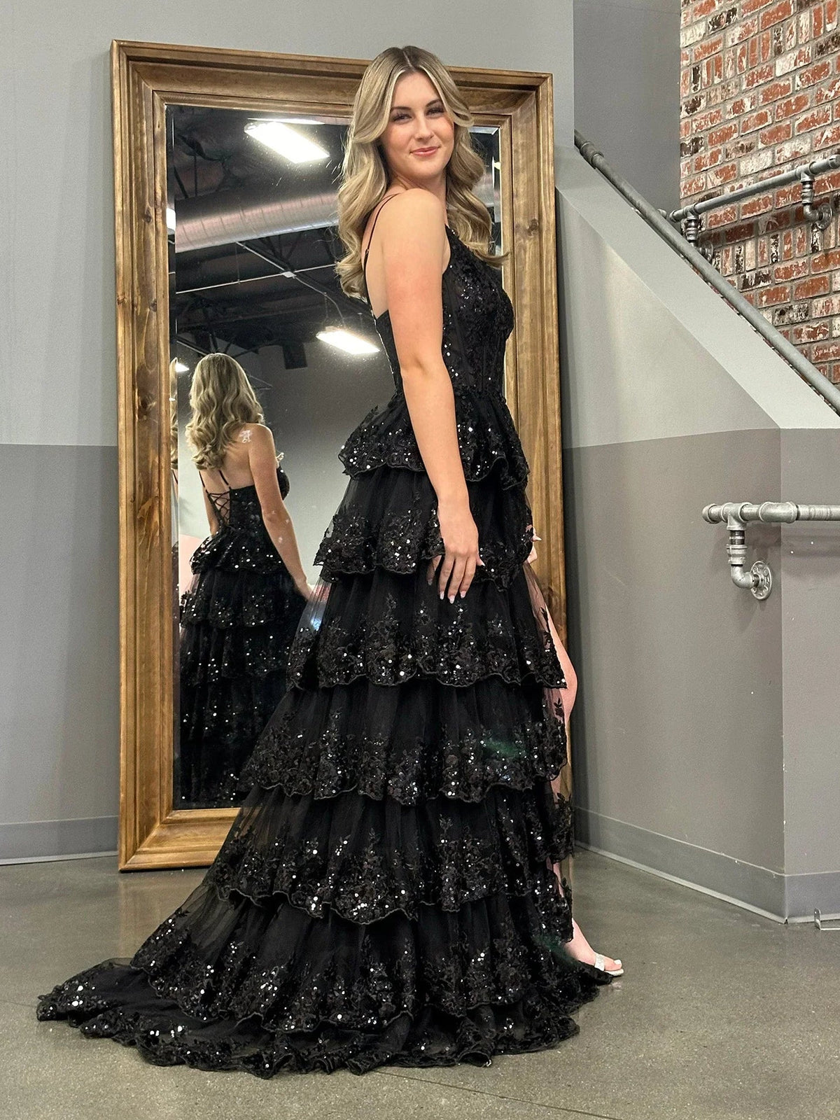 Black one-shoulder tiered maxi prom dress with corset bodice and sparkling beaded details