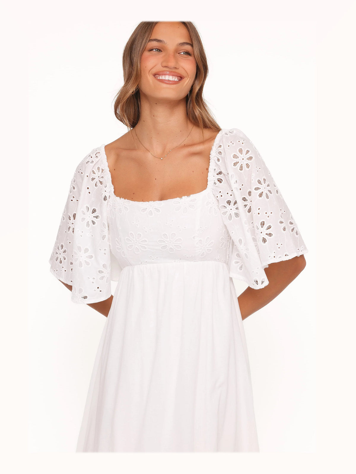 White formal dress with structured woven fabric construction and maxi hem