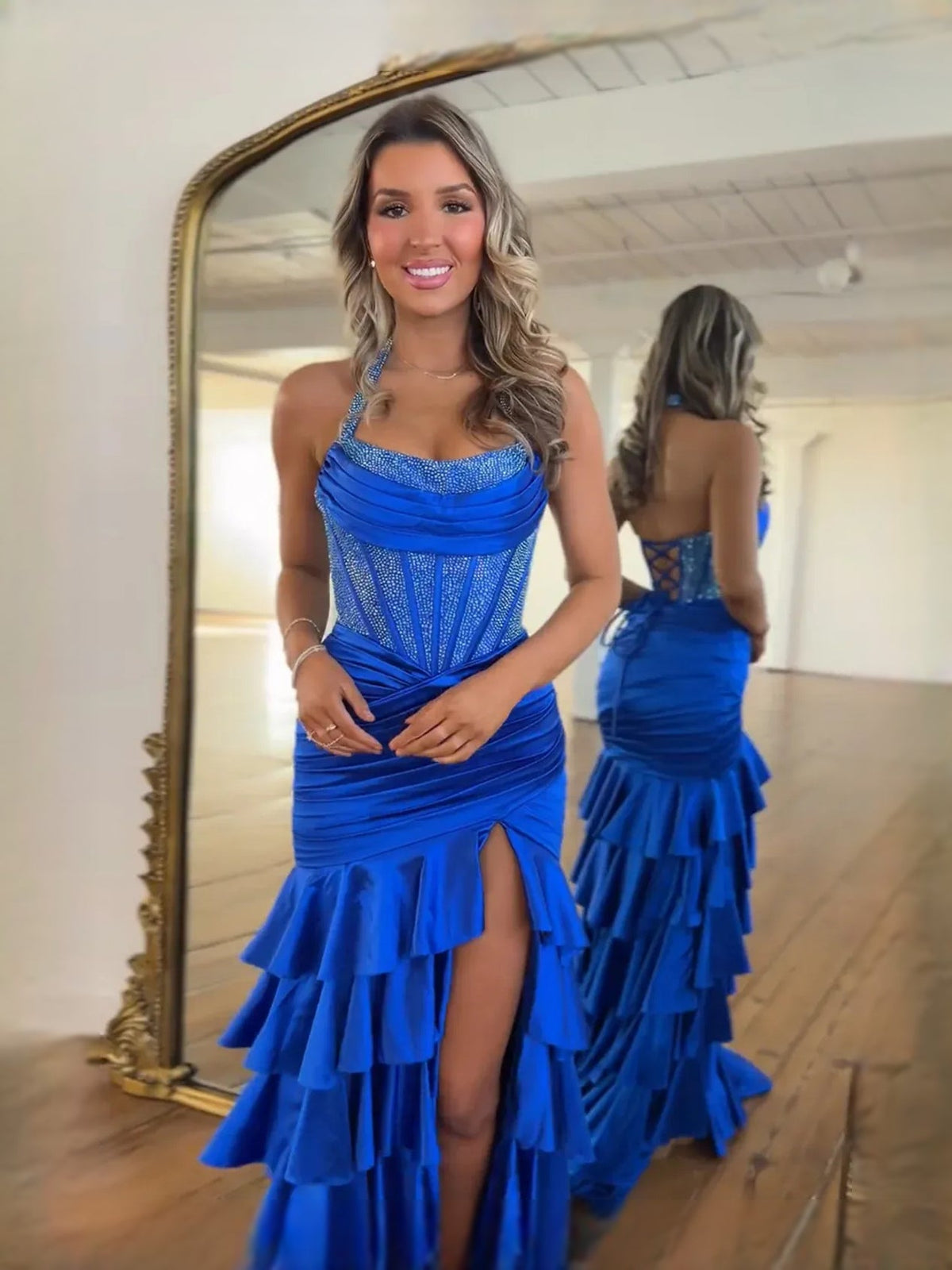 Cobalt blue corset halter prom dress with glittery bodice and layered ruffle skirt