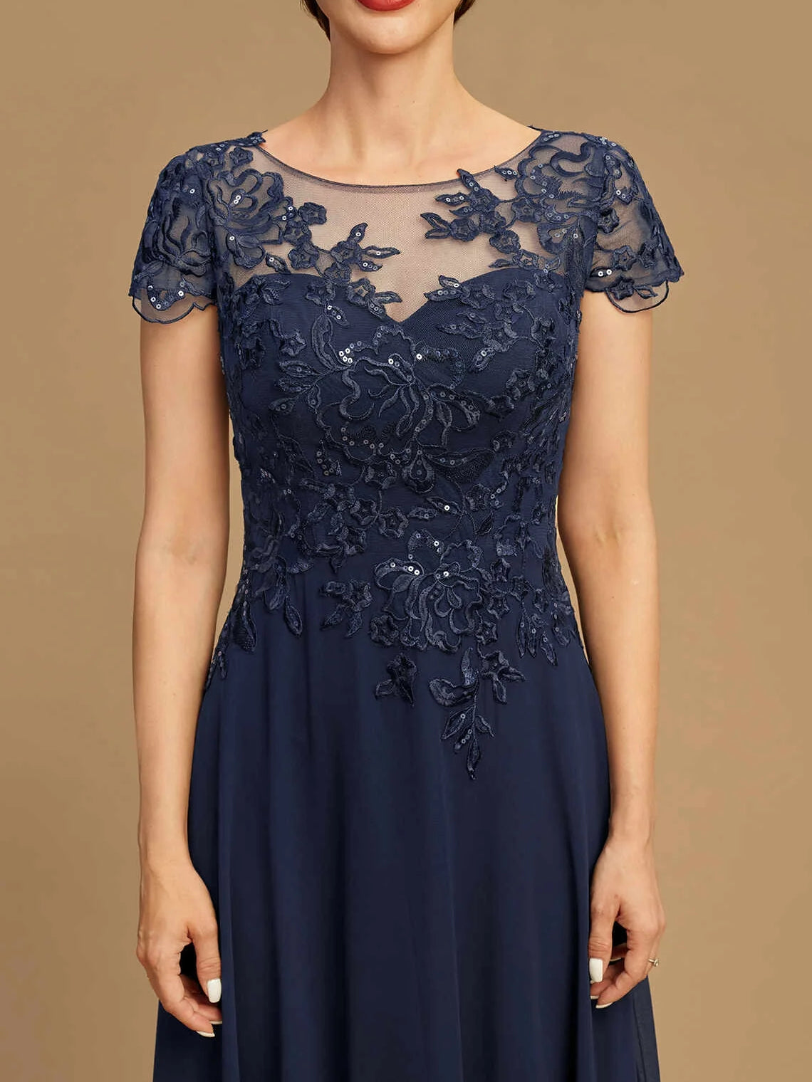 Close-up of dark navy sequin boat-neck lace bodice on an A-line chiffon dress