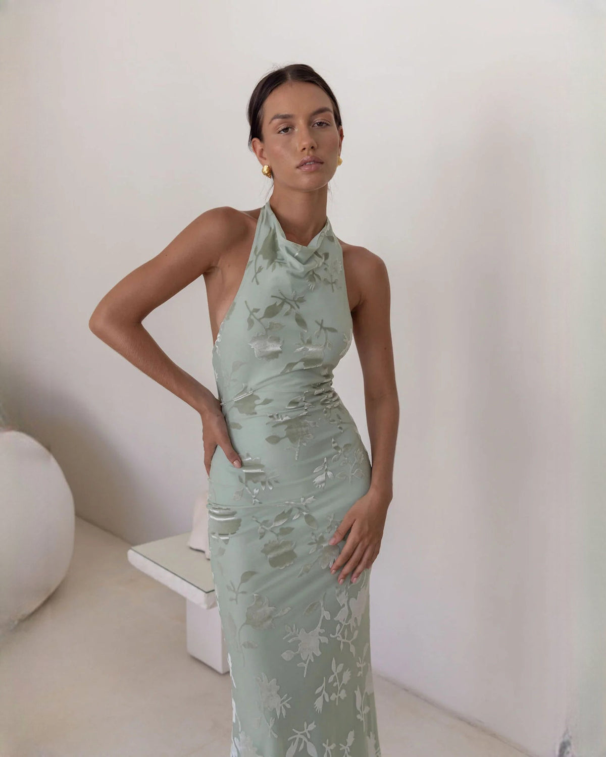 Dusty sage floral sleeveless halter maxi dress with fitted bodice and drape