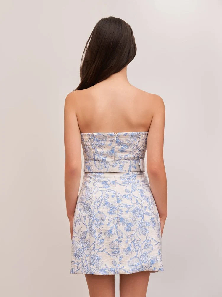 Back view of light blue strapless mini sheath dress with floral print and center seam