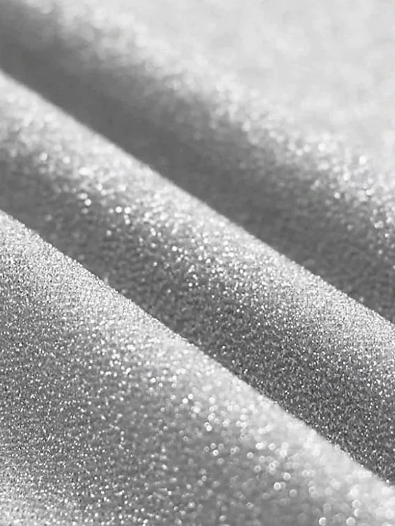 Close-up of silver glitter fabric on a diagonal band